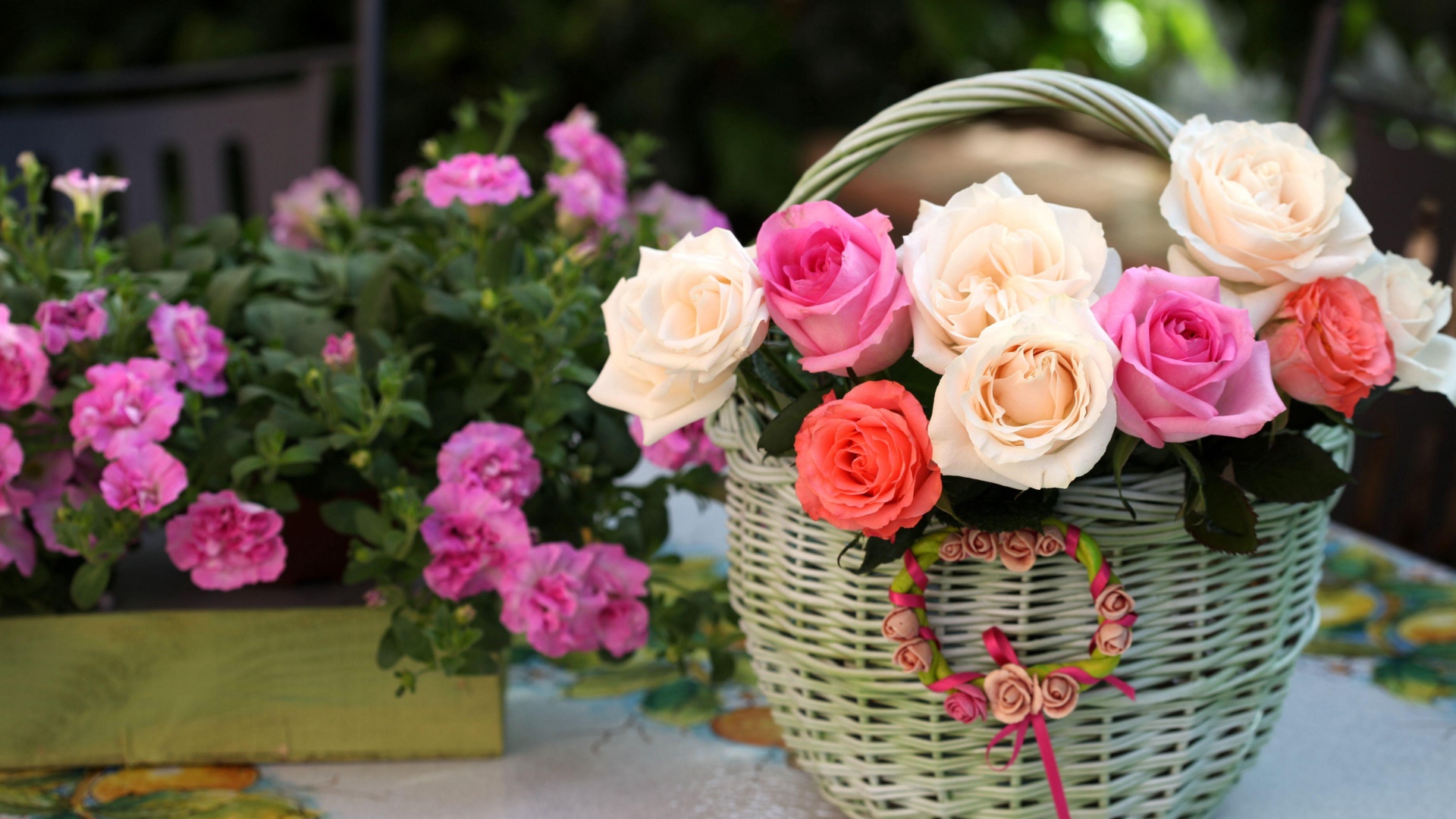 A bouquet of delicate roses in a basket on the table with flowers
