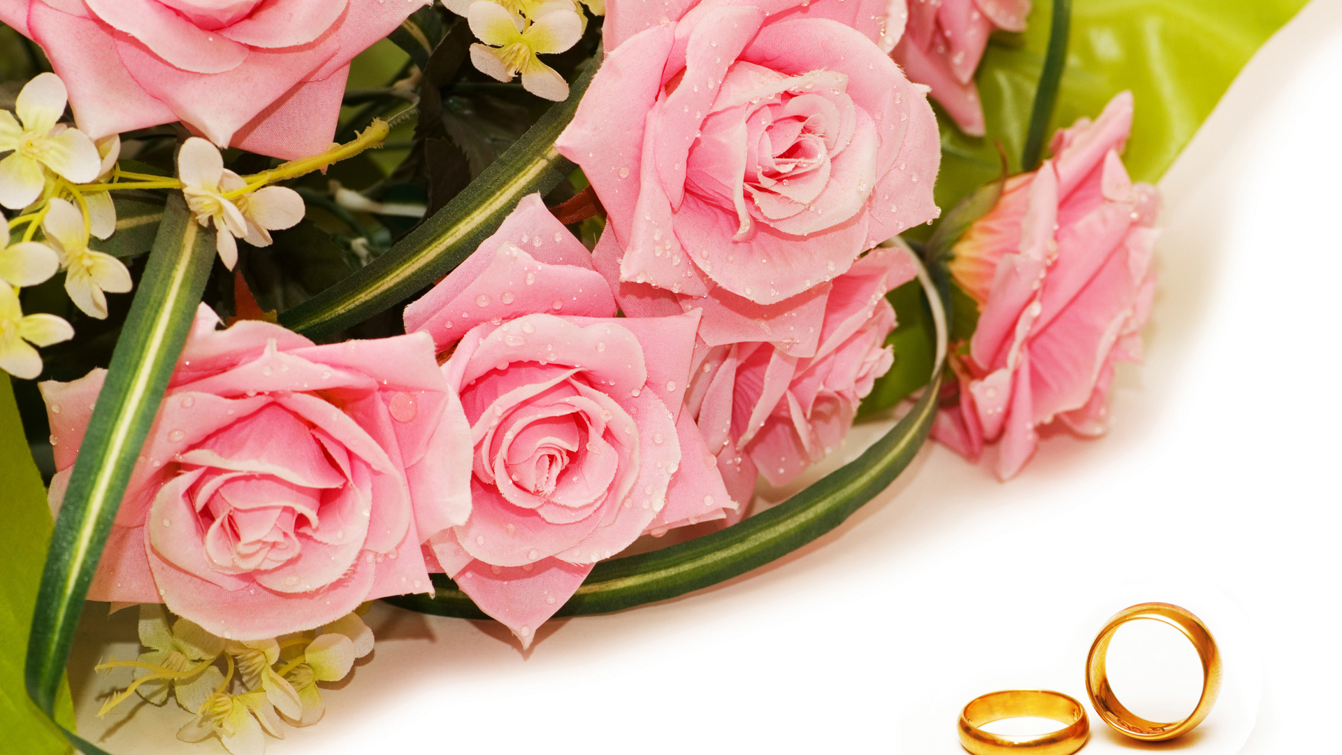 Букет розовых роз с золотыми обручальными кольцами