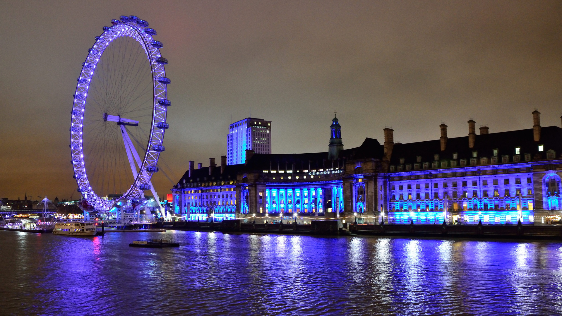 Ferris wheel by the water at night, London
