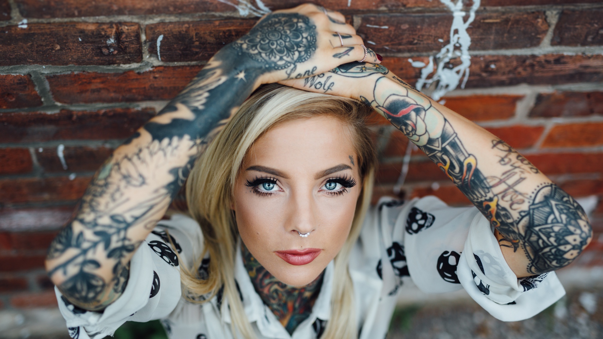 Young blond girl with tattoos on the body