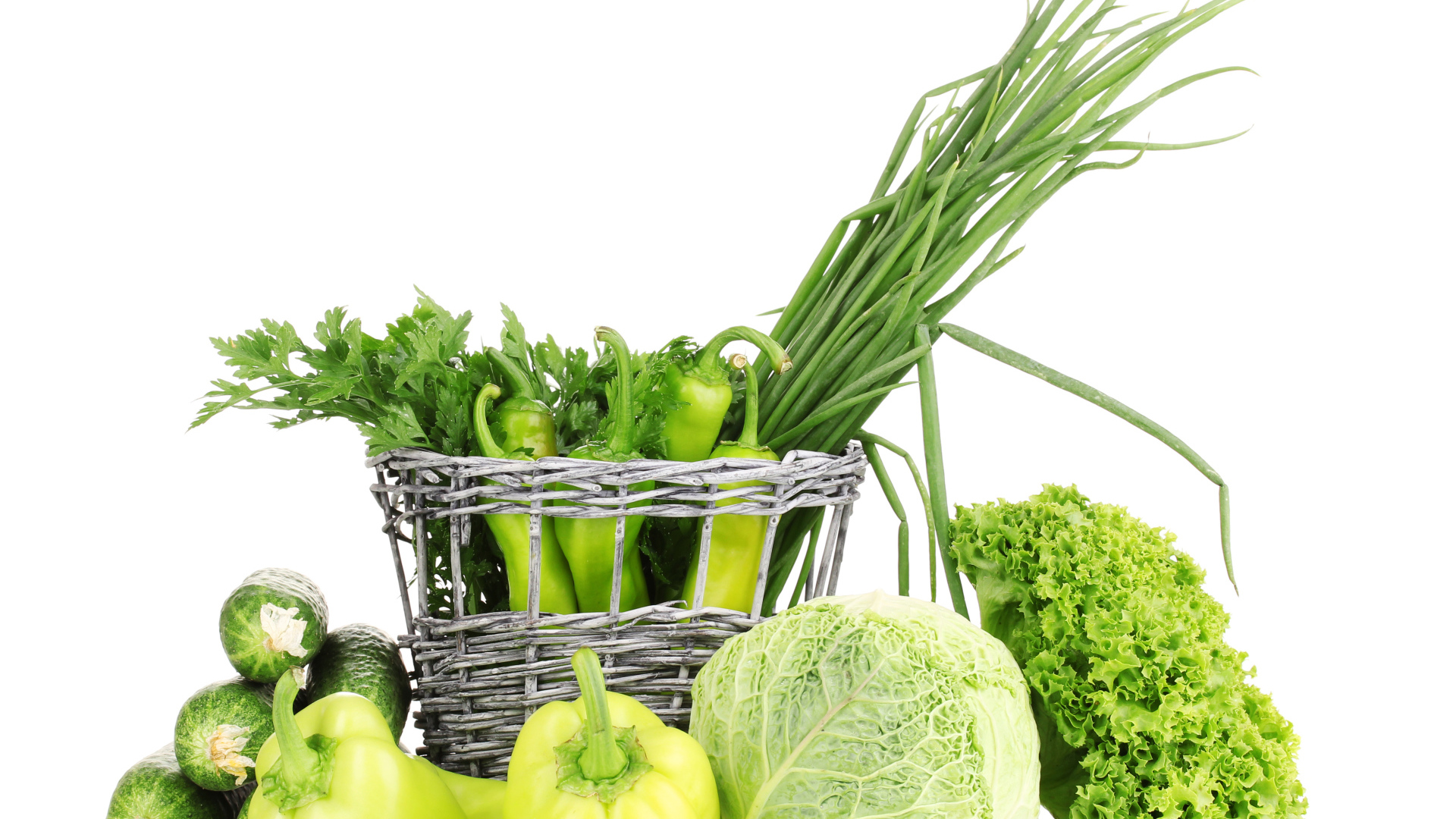 Огурцы, перец, капуста, зеленый лук и петрушка на белом фоне