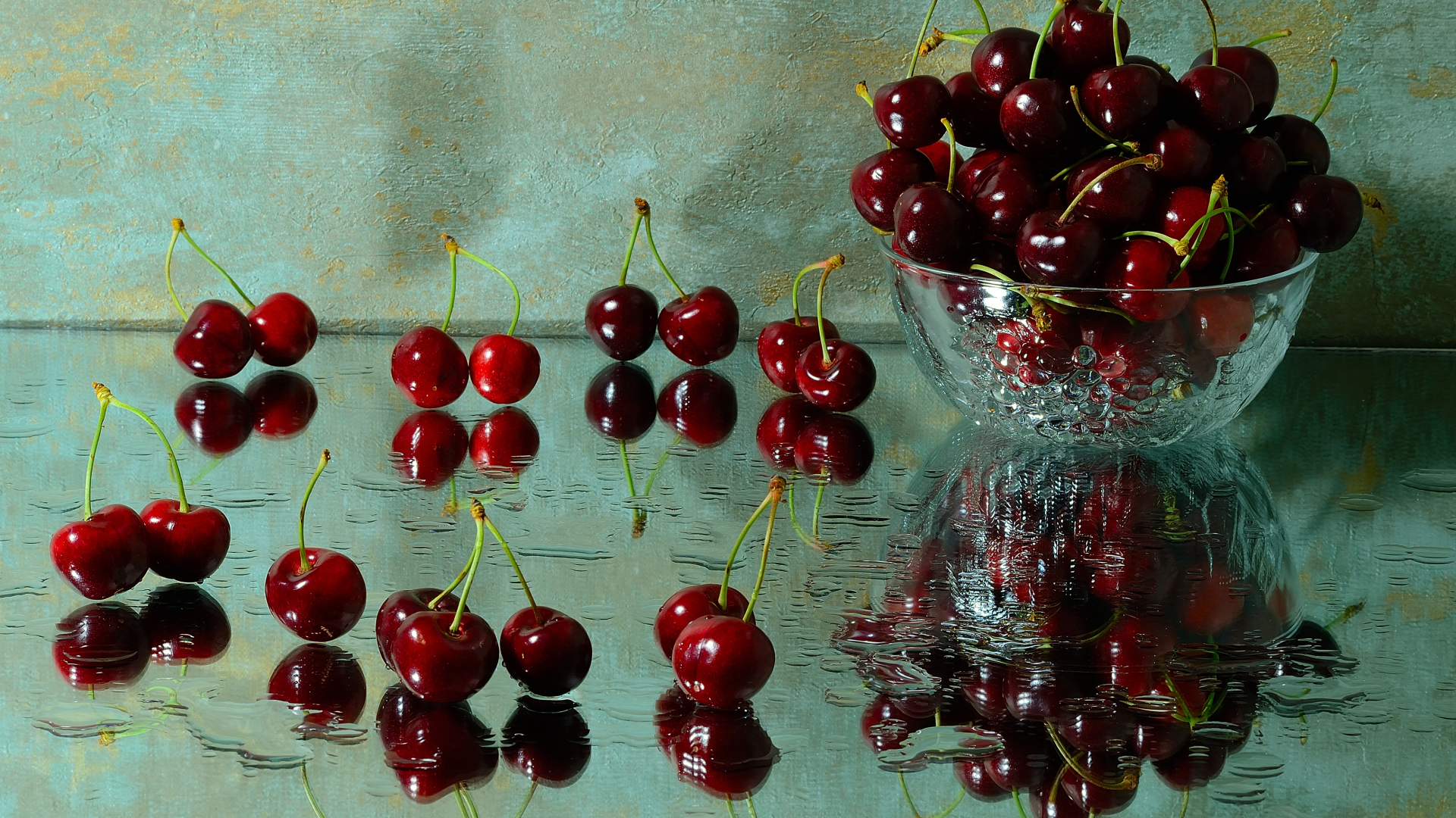 Спелые красные черешни отражаются в поверхности стола