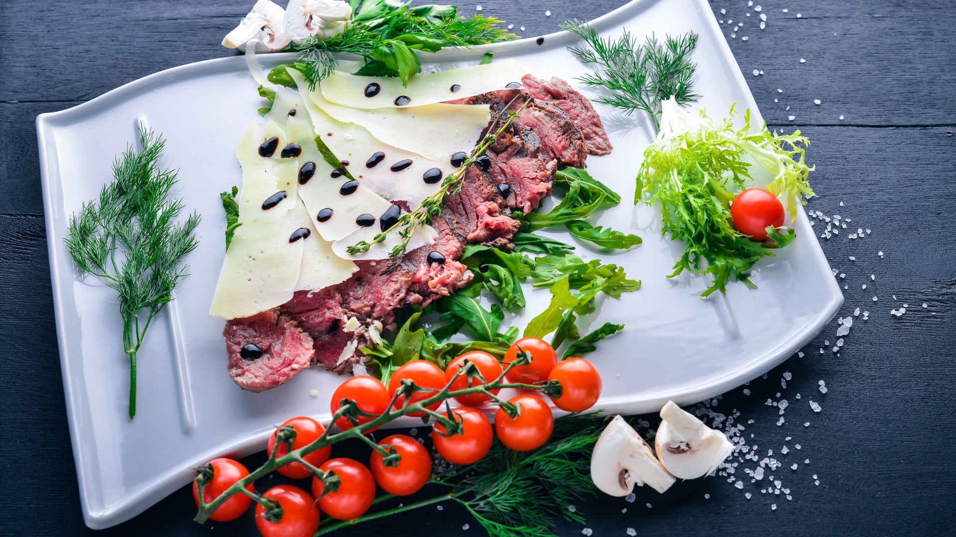 Meat with cheese, vegetables and herbs on a plate
