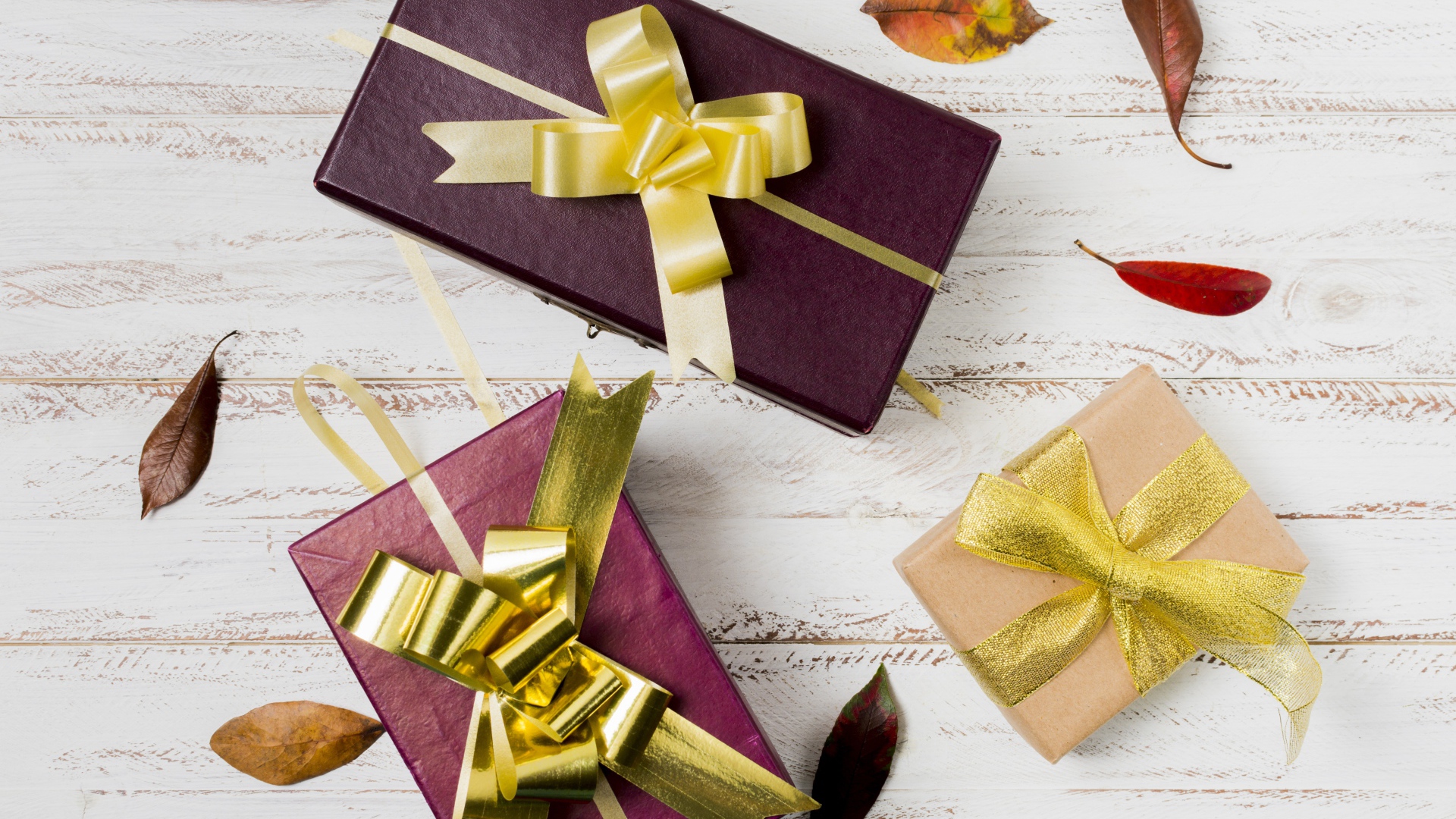 Три подарочные коробки с бантами на столе