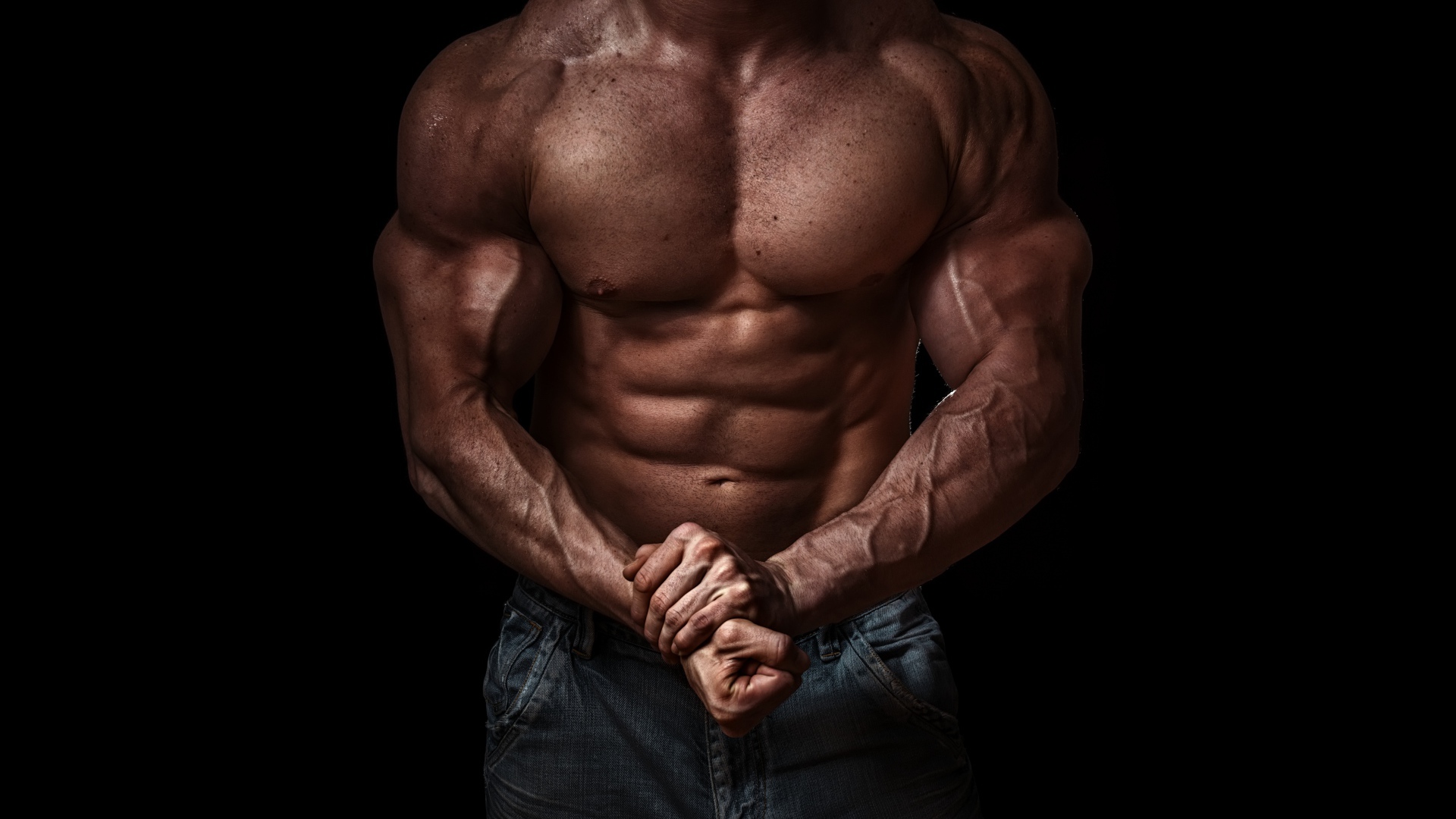 Body of a pumped man on a black background