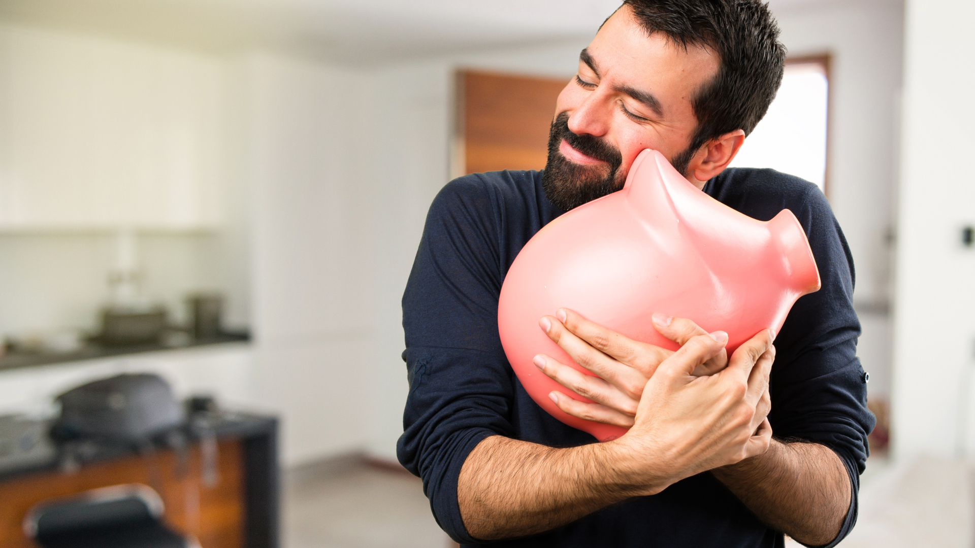 Man hugging a pink pig piggy bank