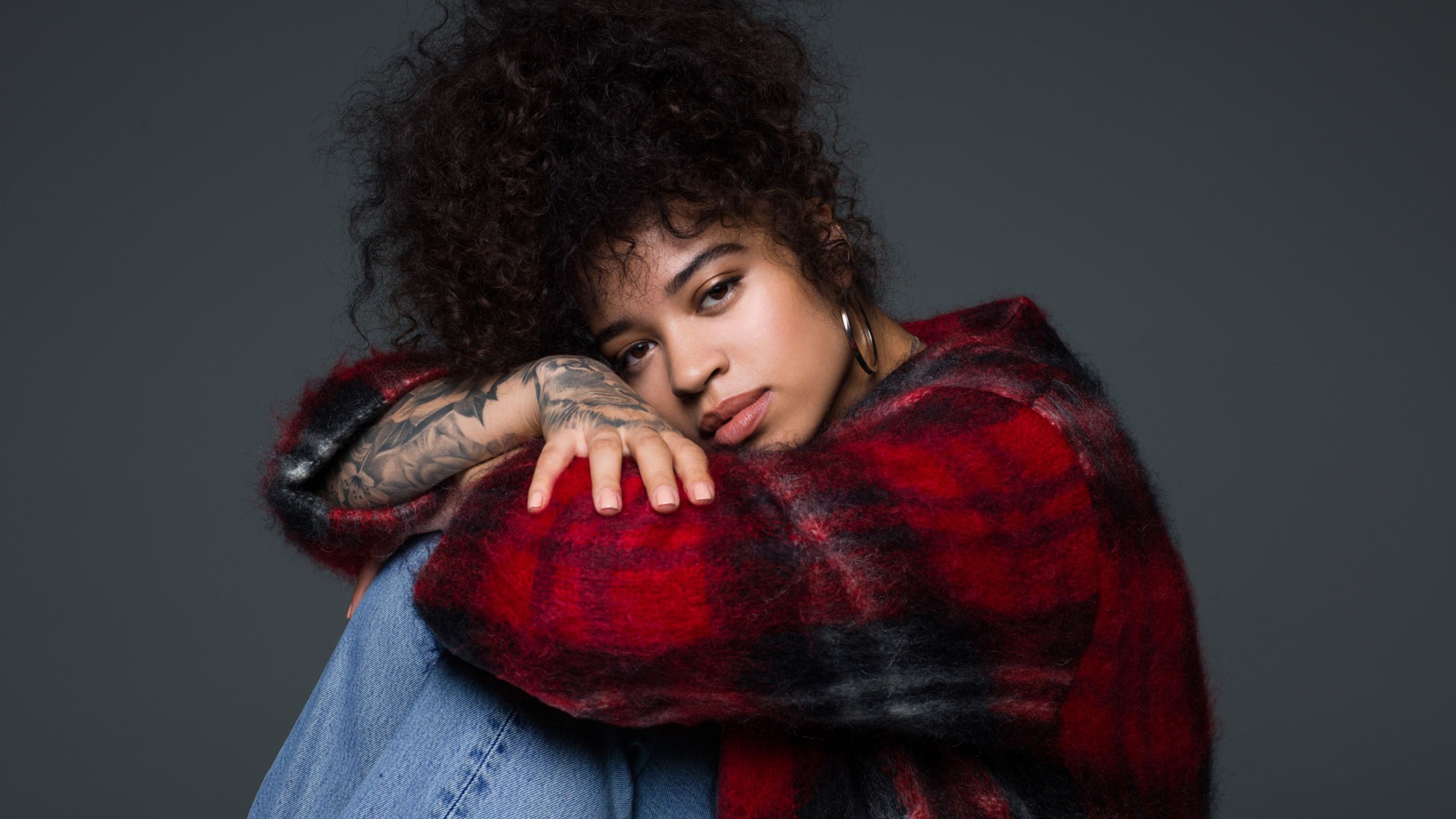 Singer Ella Mai on a gray background