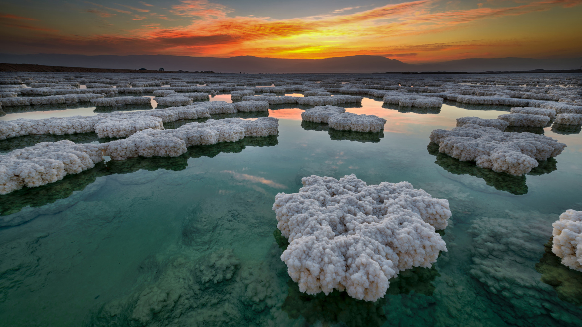 Salt deposits in the water under a beautiful sky at sunset