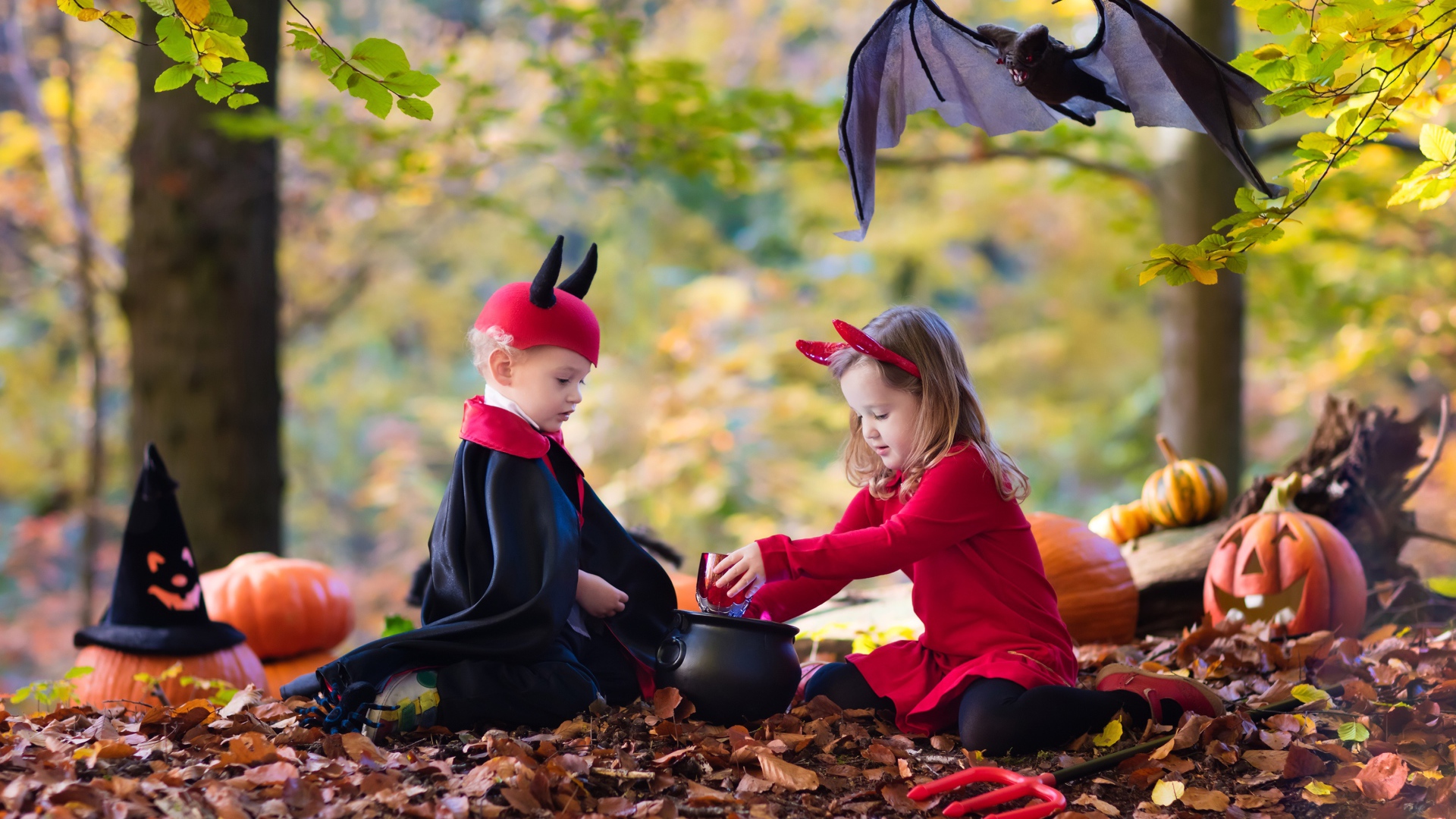 Мальчик и девочка в лесу в костюмах на праздник Хэллоуин 