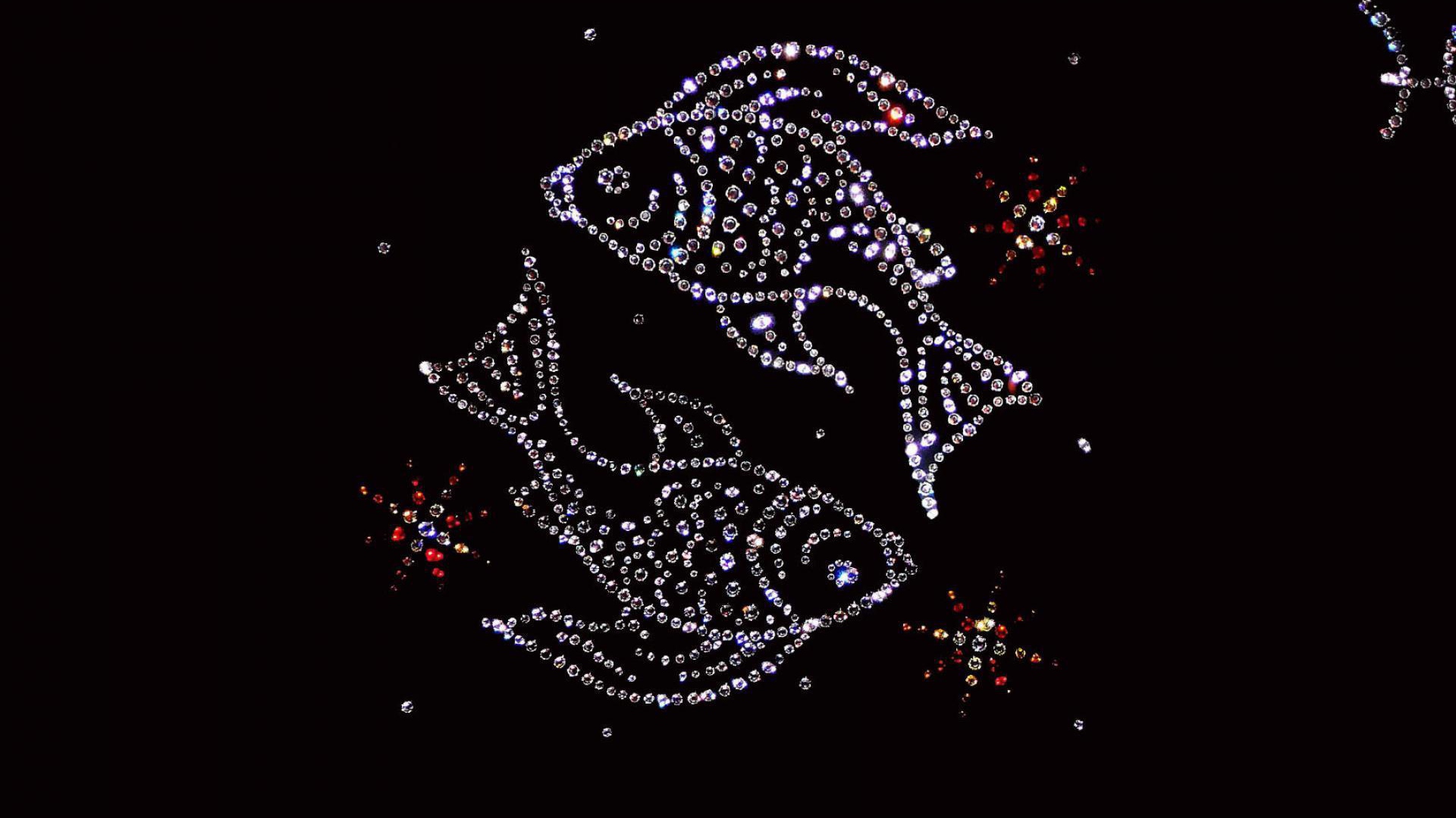 Shiny fish zodiac sign on a black background.