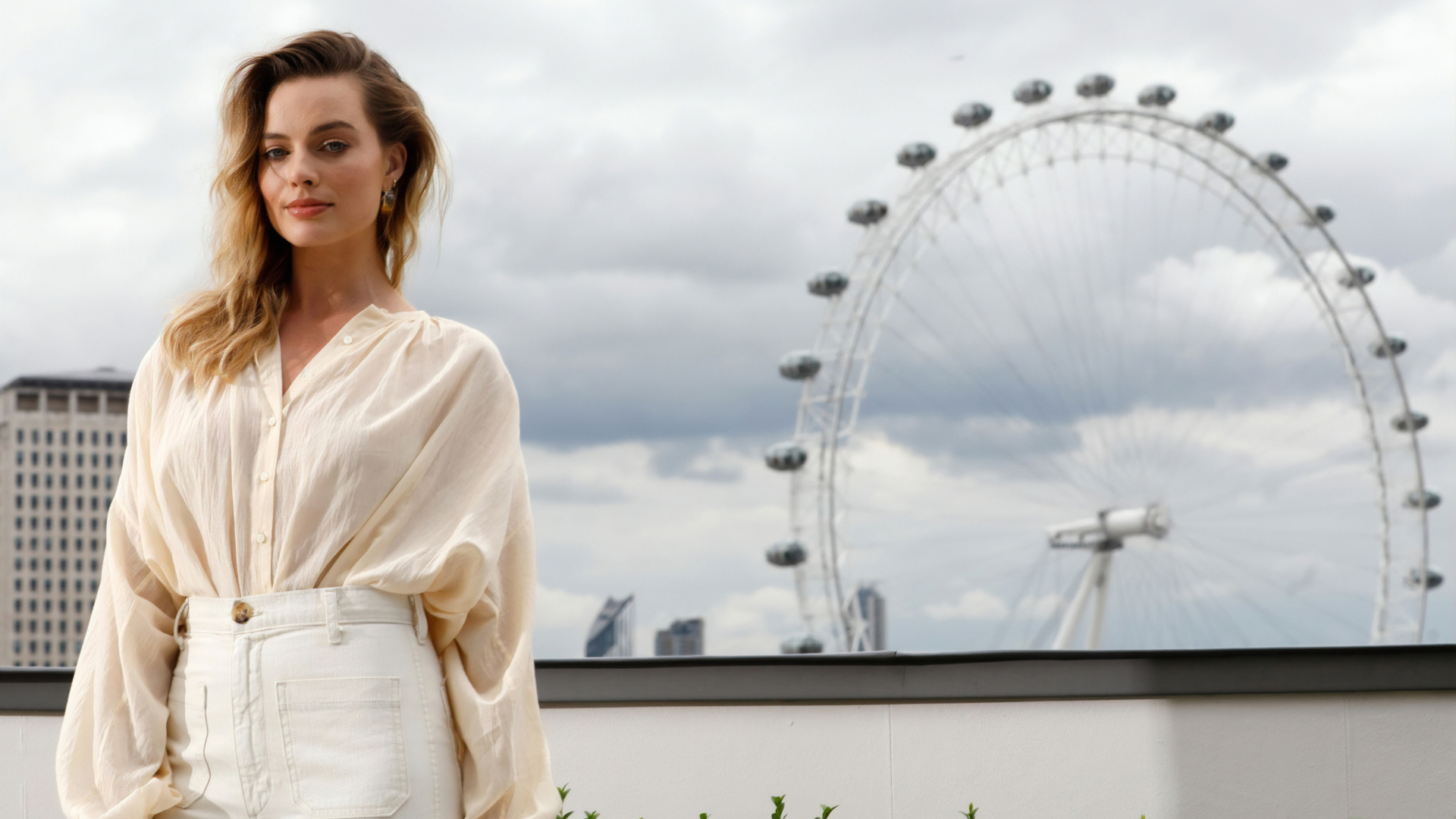 Актриса Марго Робби на  фоне аттракциона  колесо обозрения