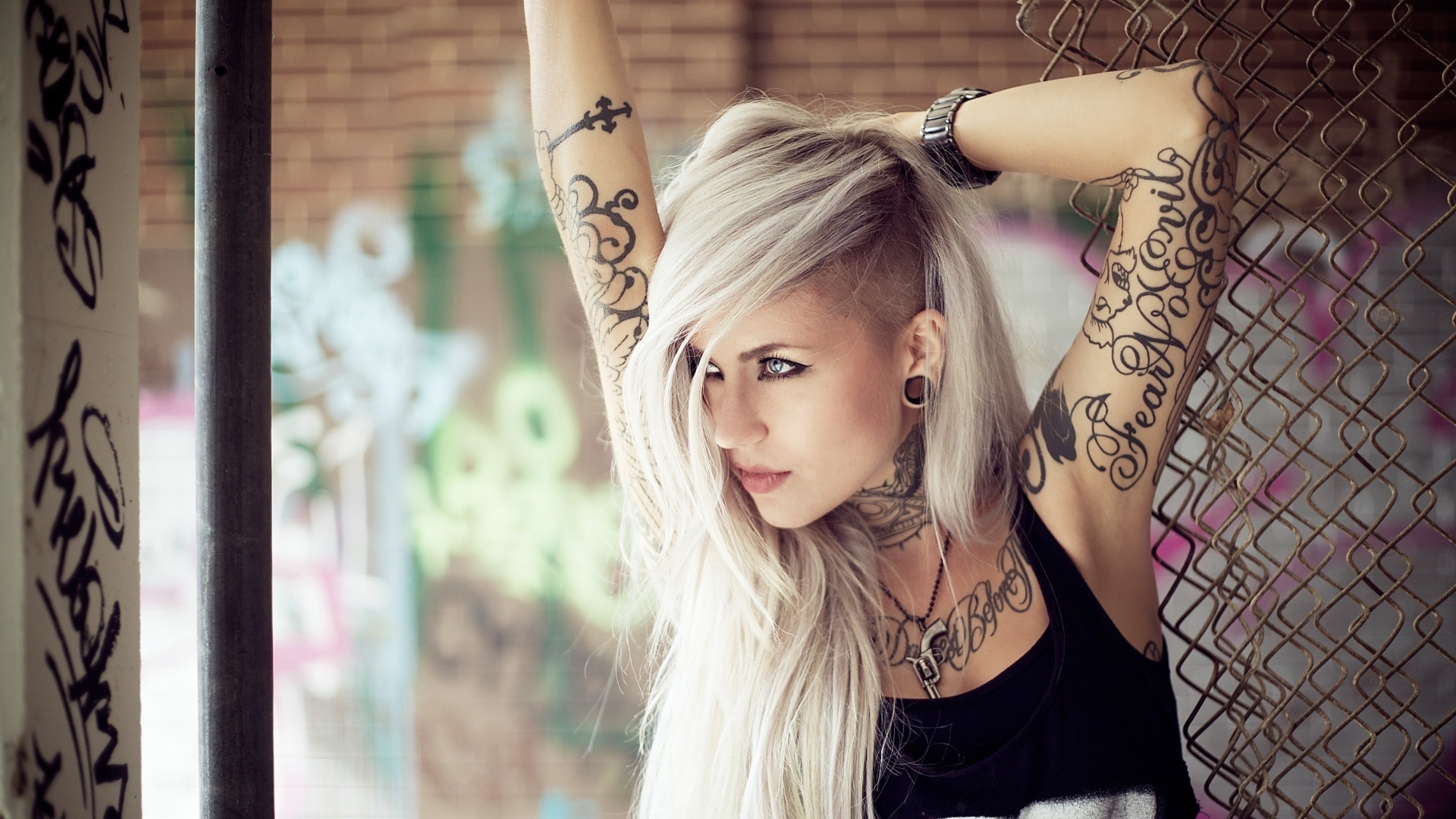 Beautiful blonde with tattoos on her body