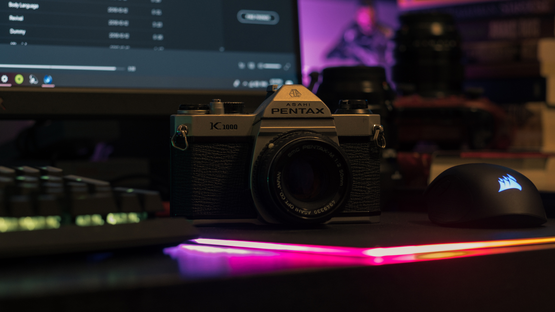 Pentax camera on the table with a computer