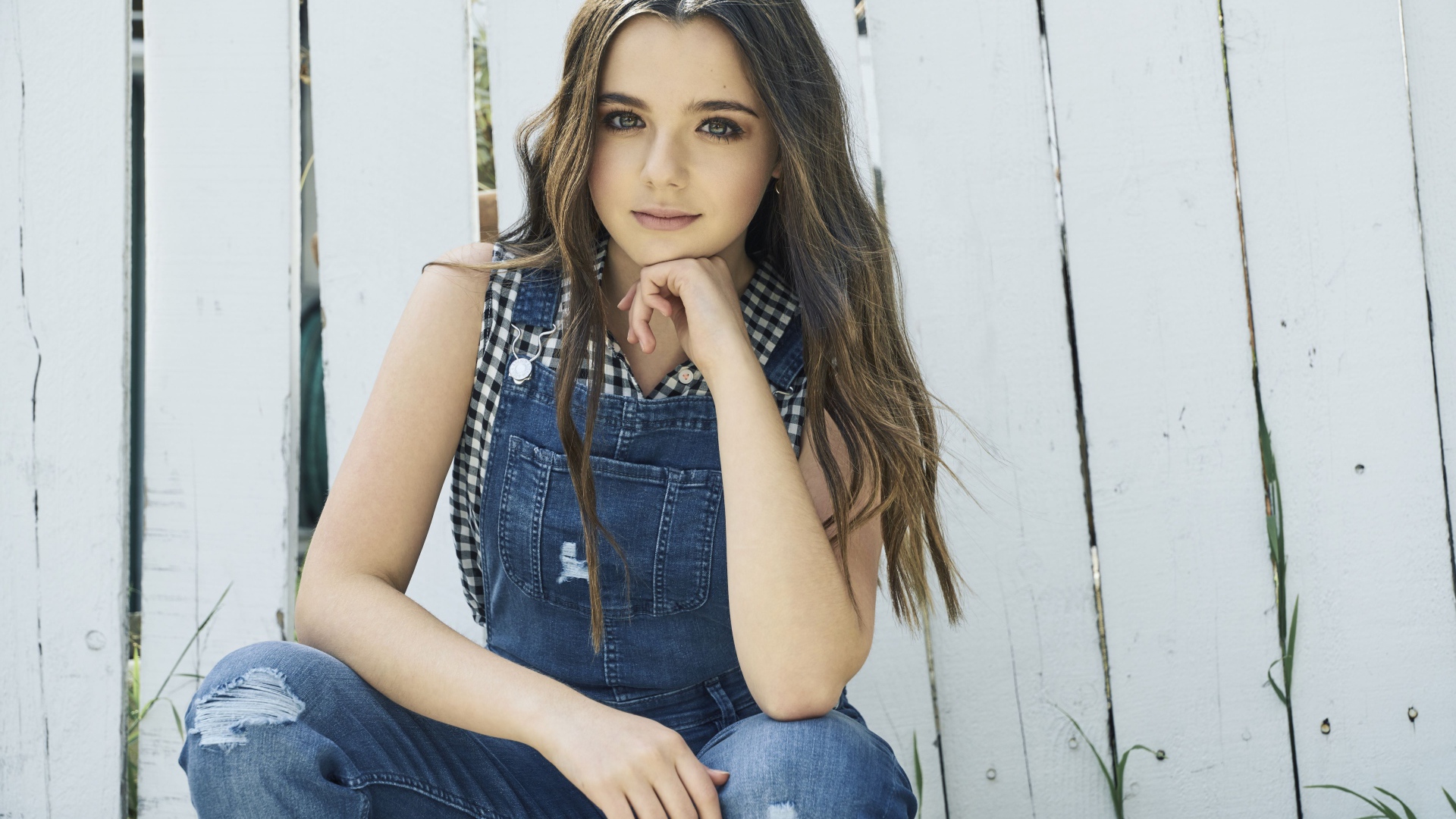 Молодая девушка, актриса Алекса Нисенсон у забора