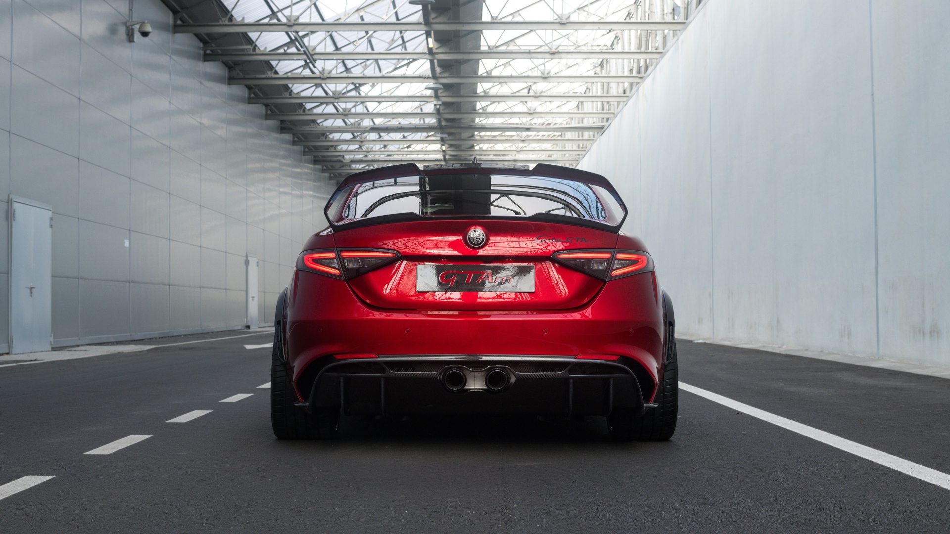 Красный автомобиль Alfa Romeo Giulia GTAm 2020 года вид сзади