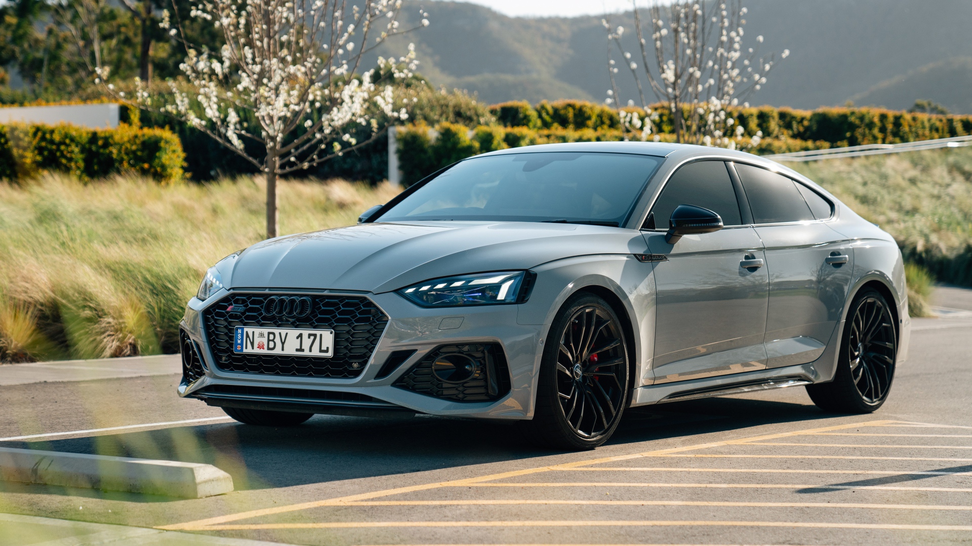 Серебристый автомобиль Audi RS 5 Sportback 2020 года на дороге