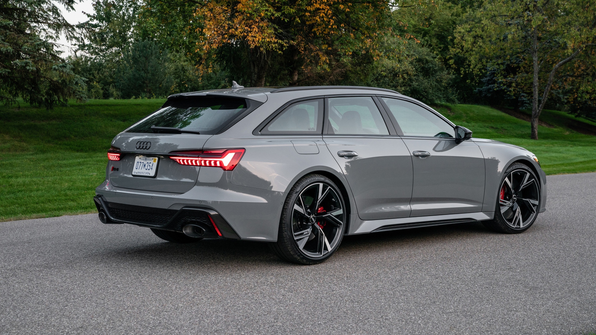 Серебристый автомобиль Audi RS 6 Avant, 2021 года вид сзади