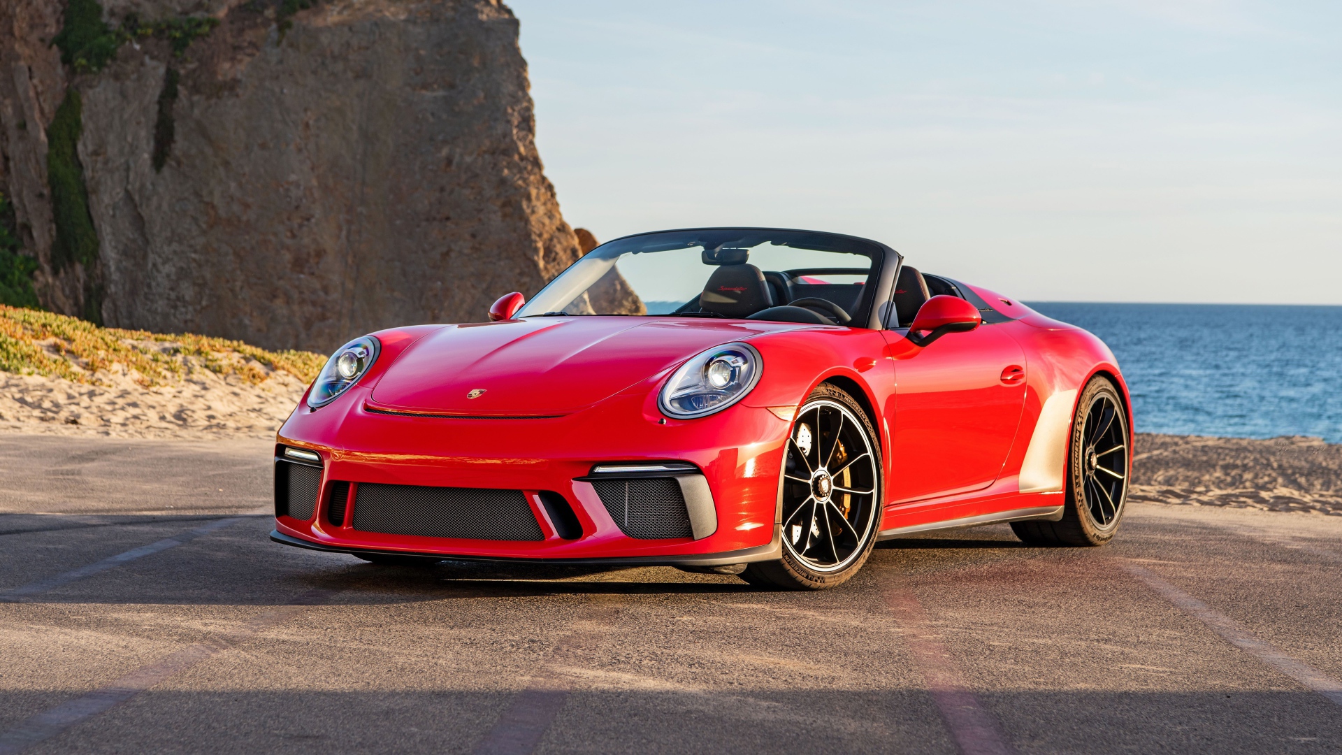 Красный автомобиль Porsche 911 Speedster, 2019 года у воды