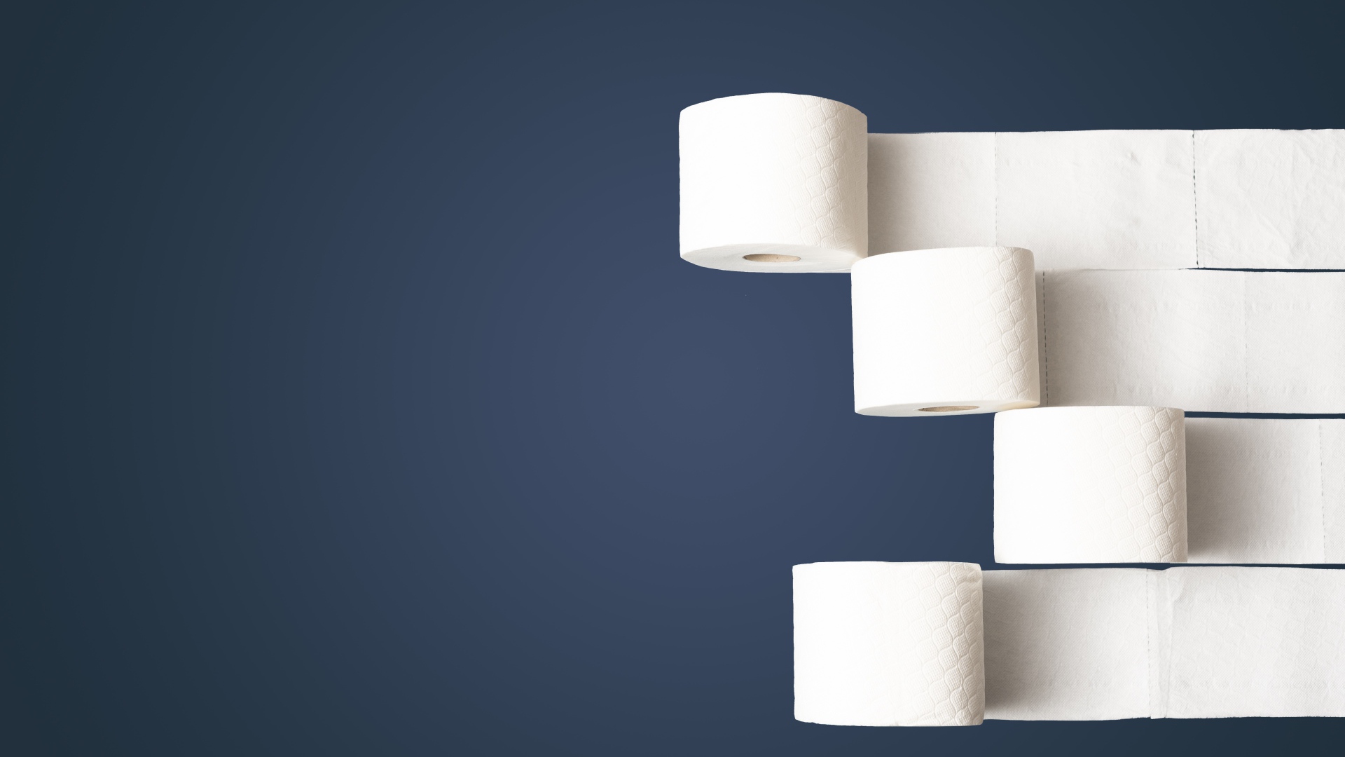 Four rolls of white toilet paper on gray background
