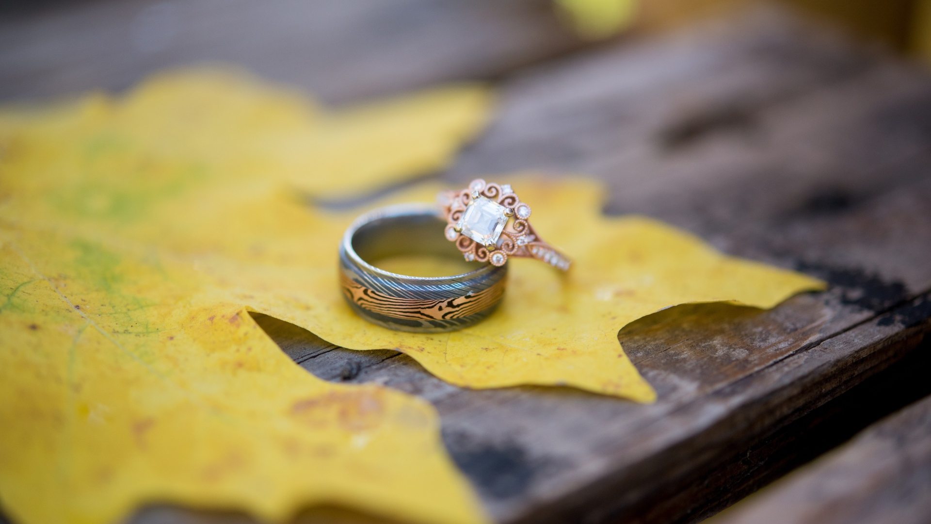 Gold rings with yellow leaf on the table