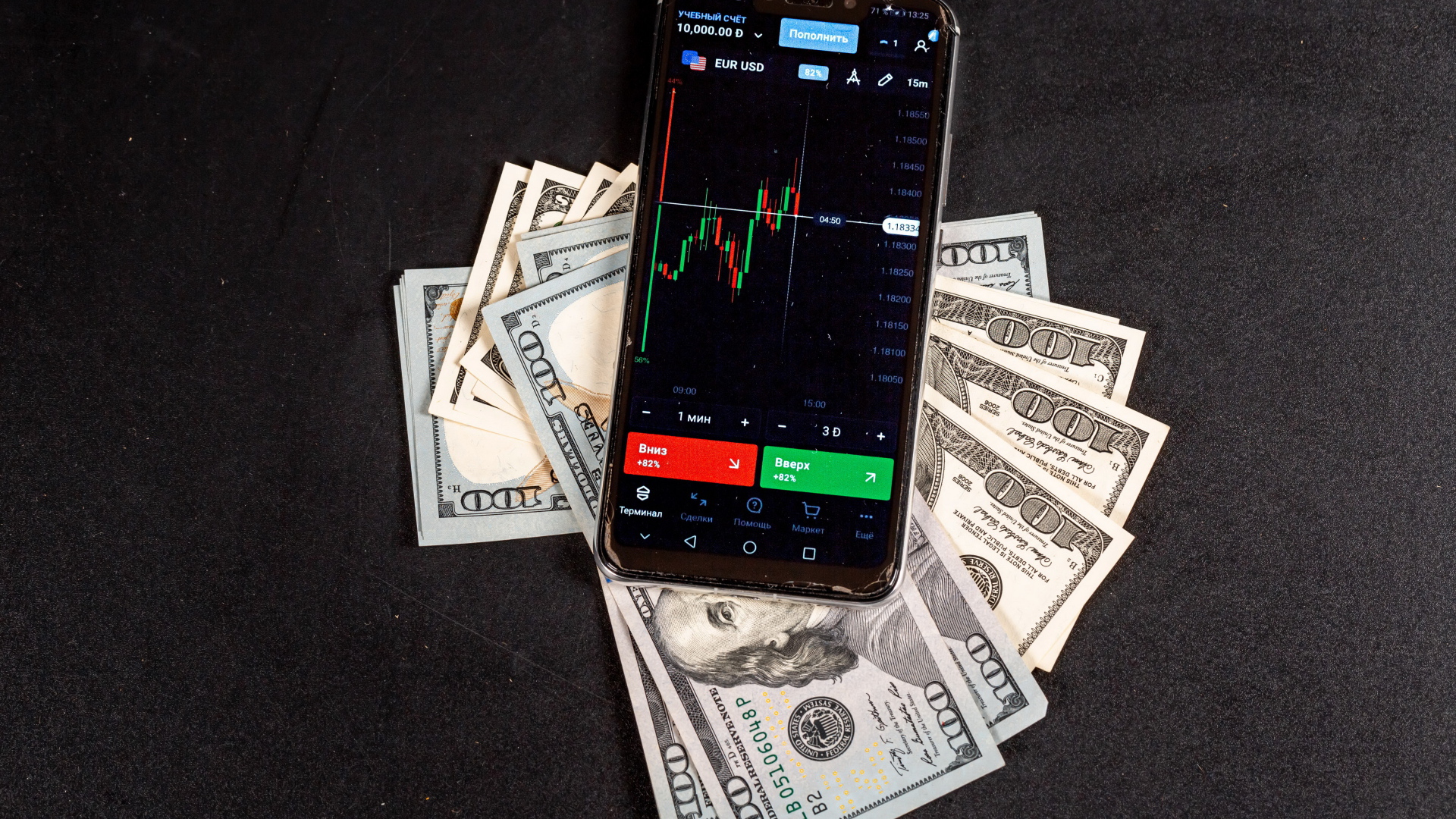 Доллары и смартфон на сером столе 