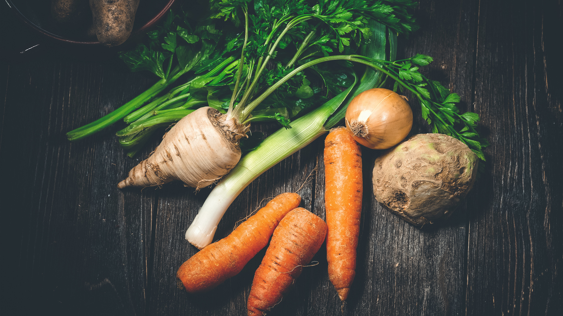 Сельдерей, морковь и лук на столе 