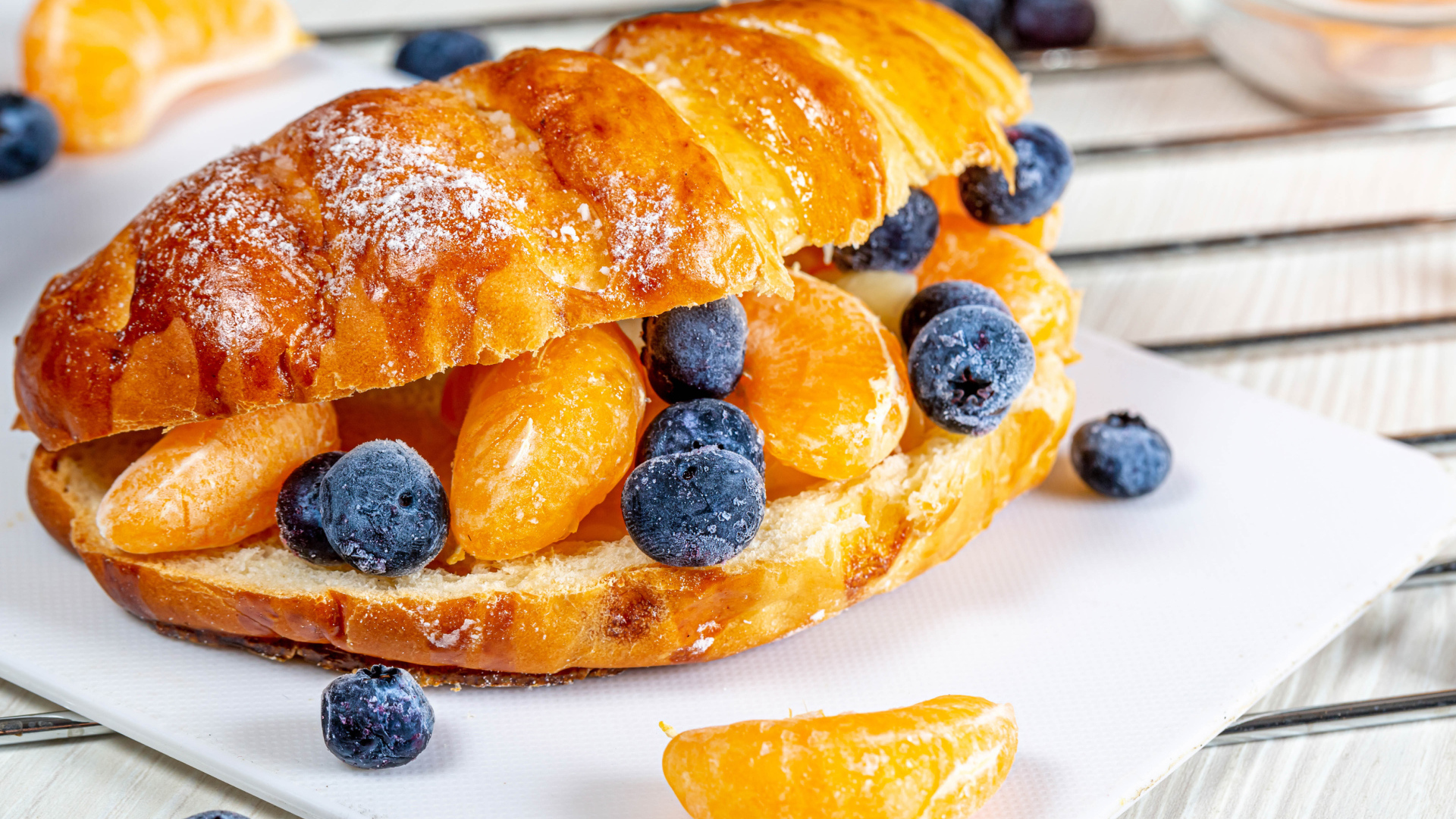 Круассан с дольками мандарина и черникой 