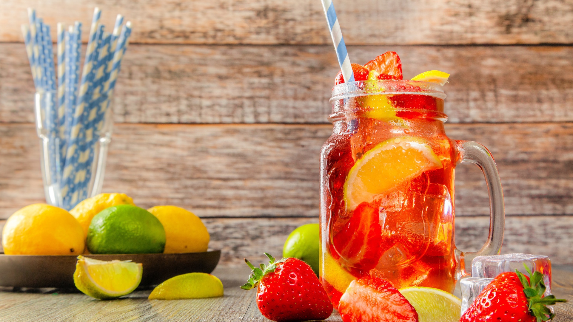 Напиток с клубникой и лимоном в банке на столе 