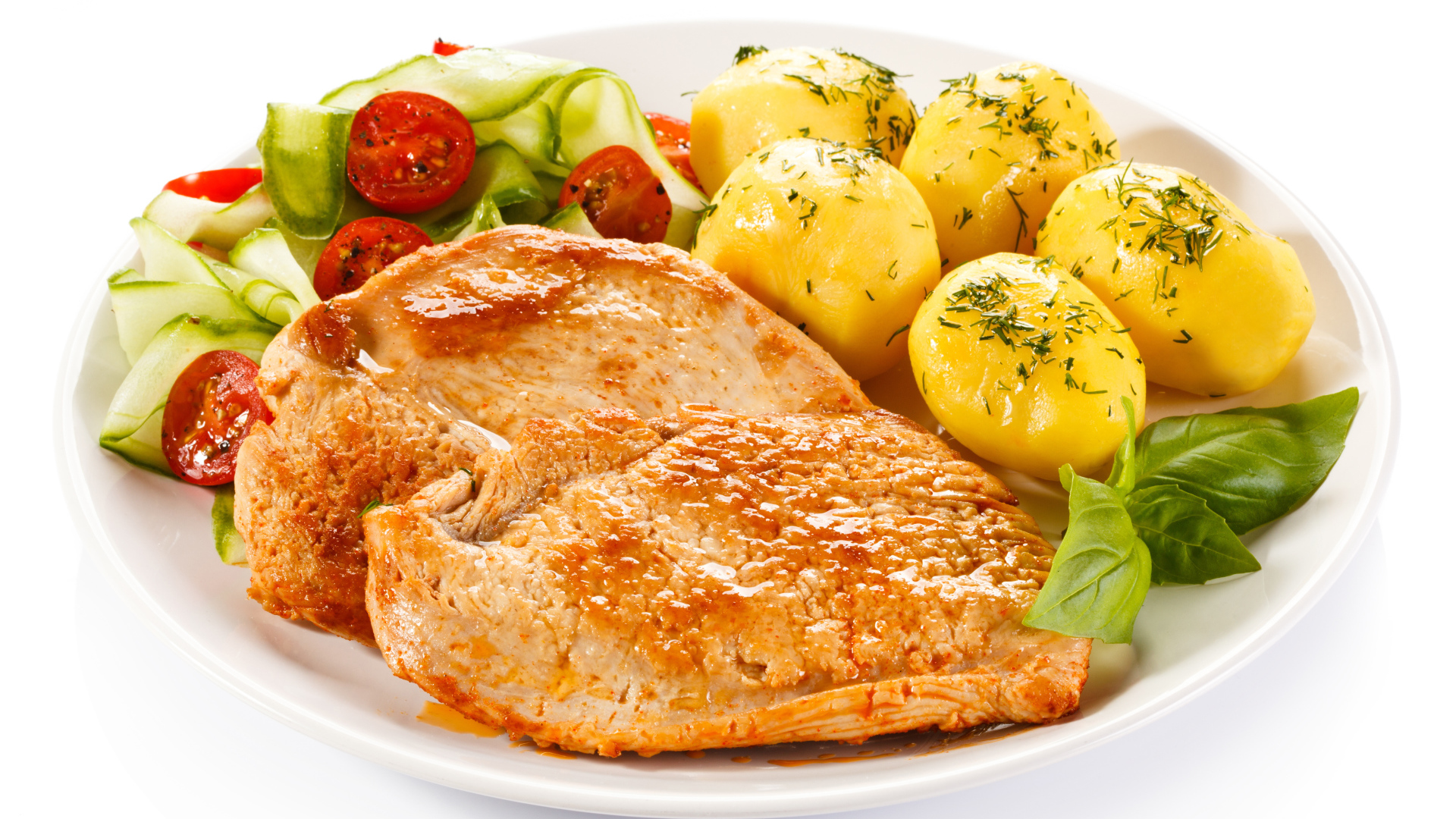 Кусок сочного куриного мяса на тарелке с картофелем и салатом