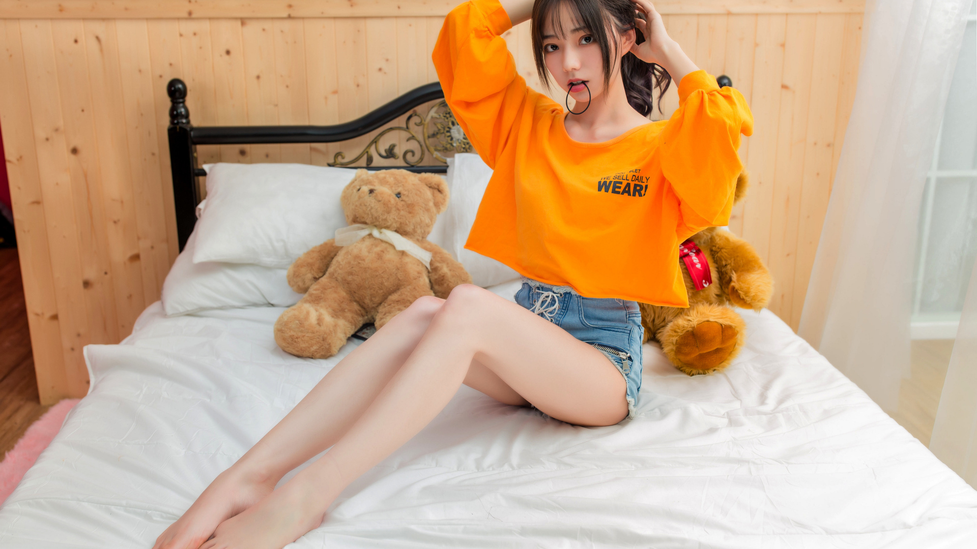 Девушка азиатка на кровати с игрушками