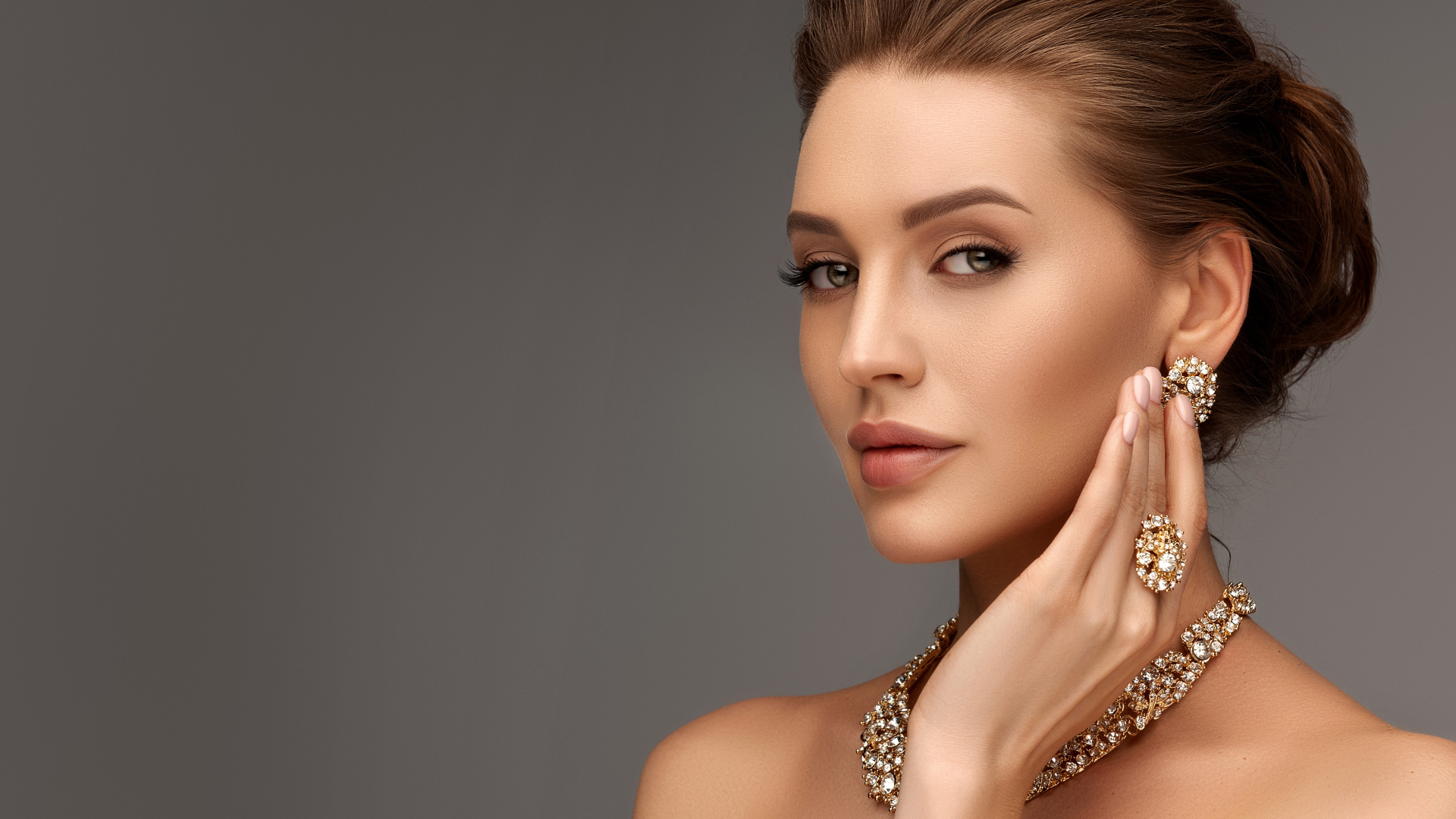 Красивая девушка с вечерней прической и дорогими украшениями