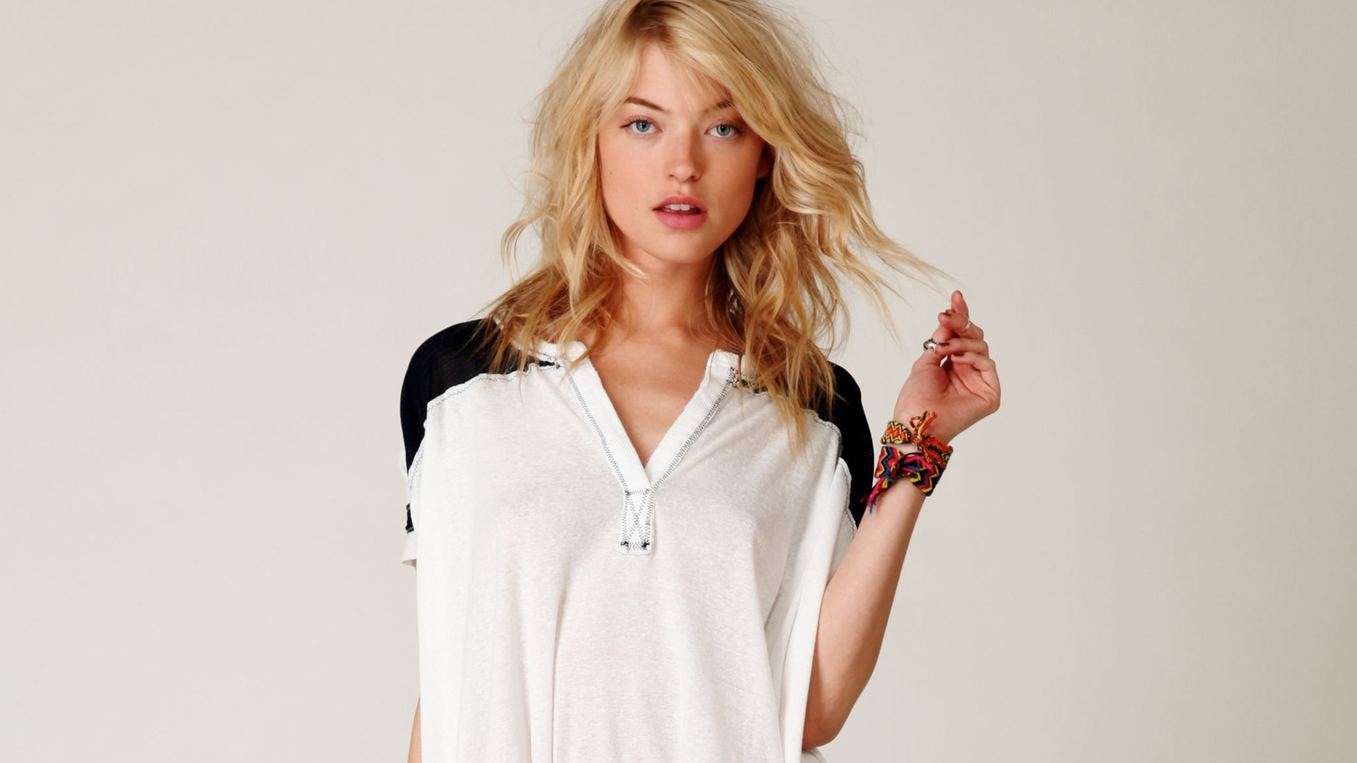 Model Martha Hunt in a t-shirt on a gray background