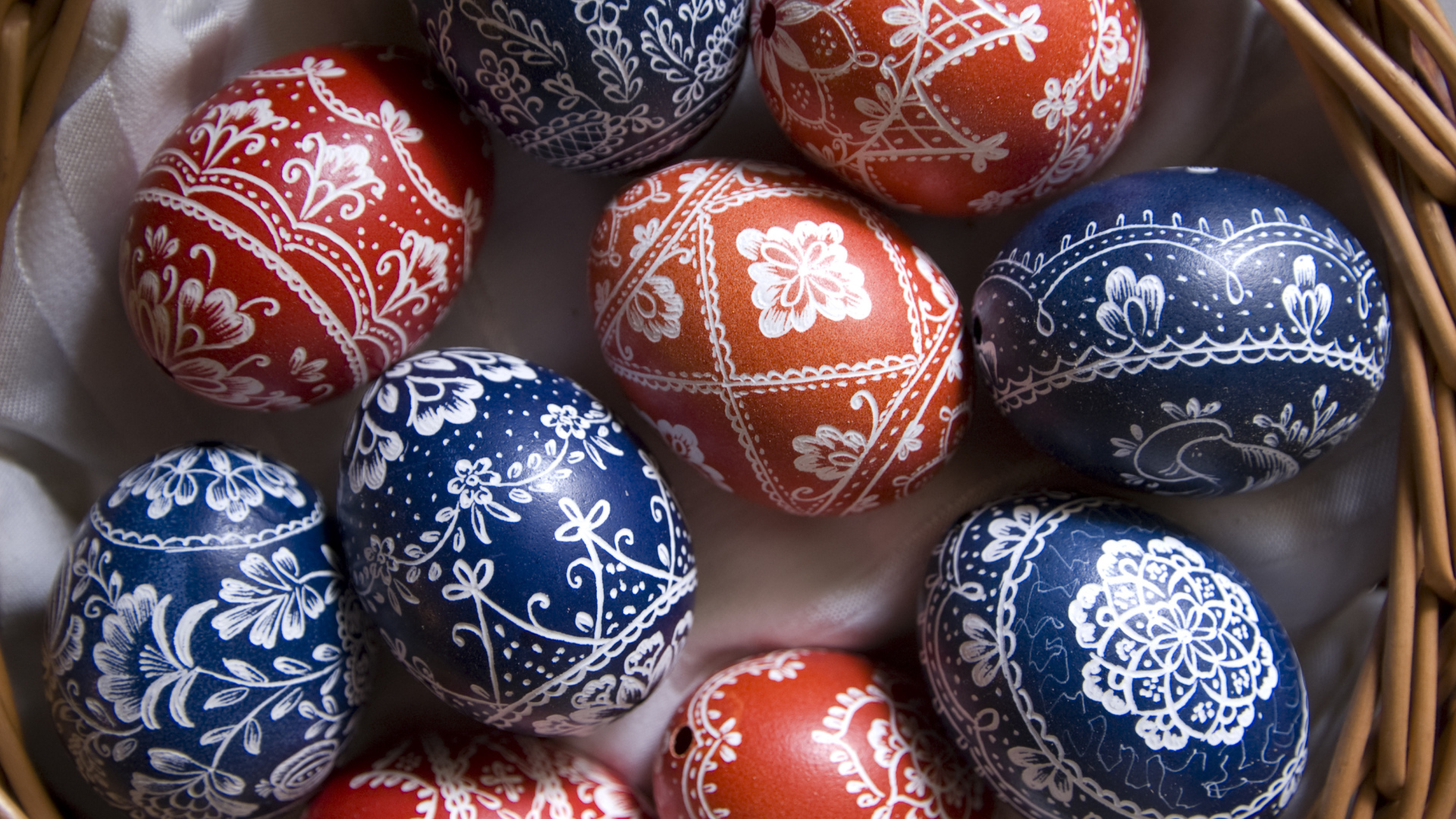 Крашеные яйца с красивым рисунком в корзине на Пасху