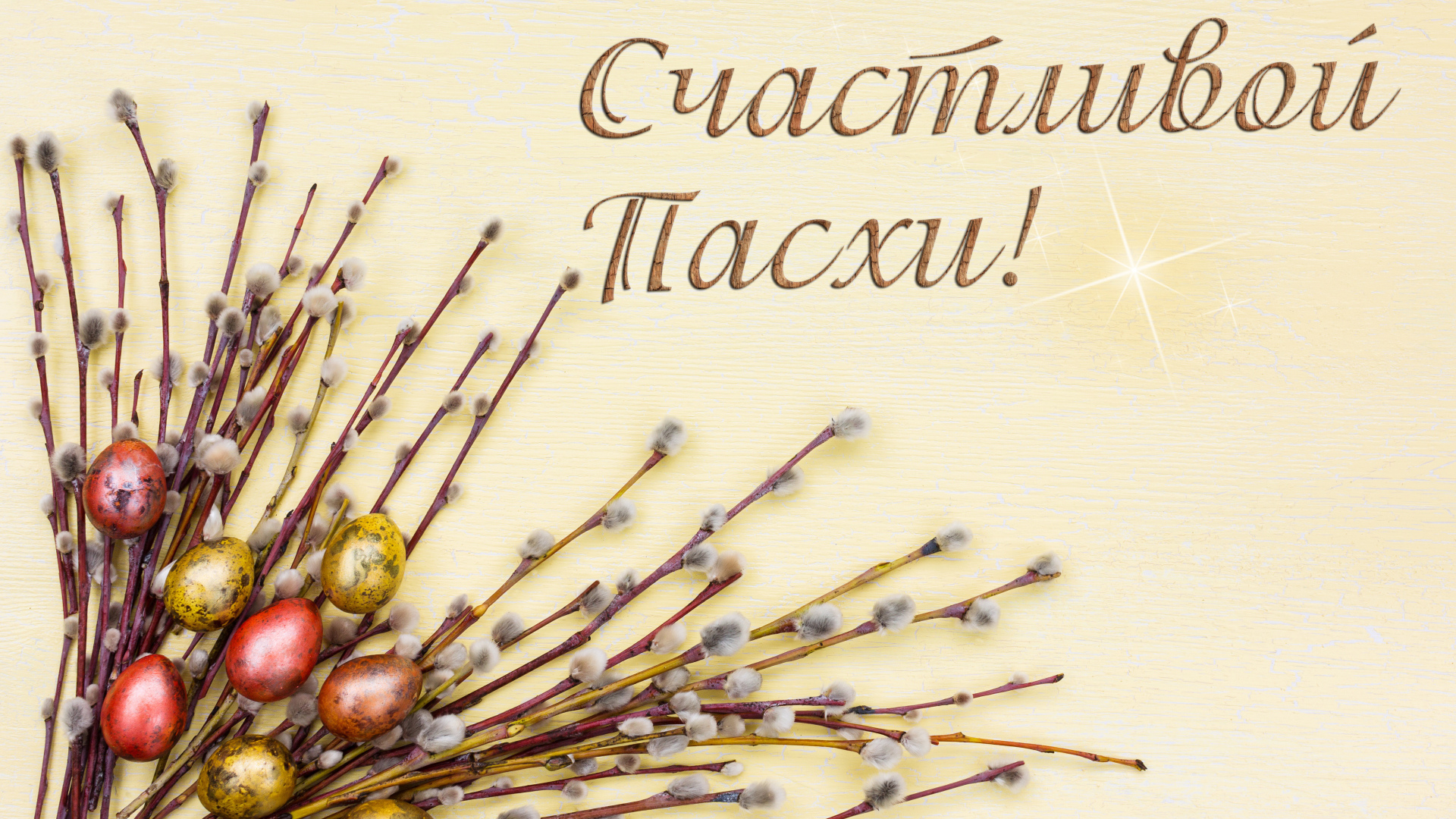 Ветки вербы и крашеные яйца с надписью Счастливой Пасхи