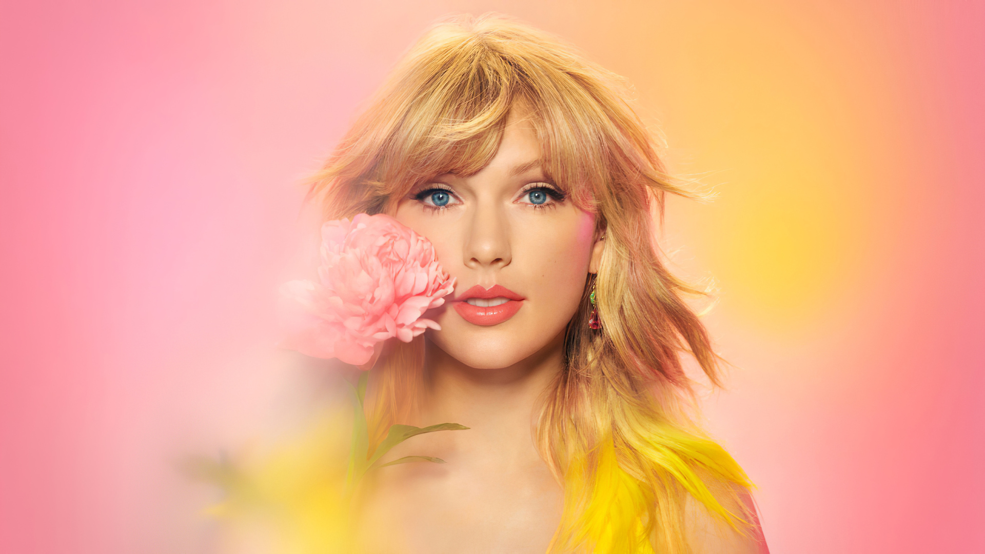 Cute blue-eyed singer Taylor Swift with a flower in his hand