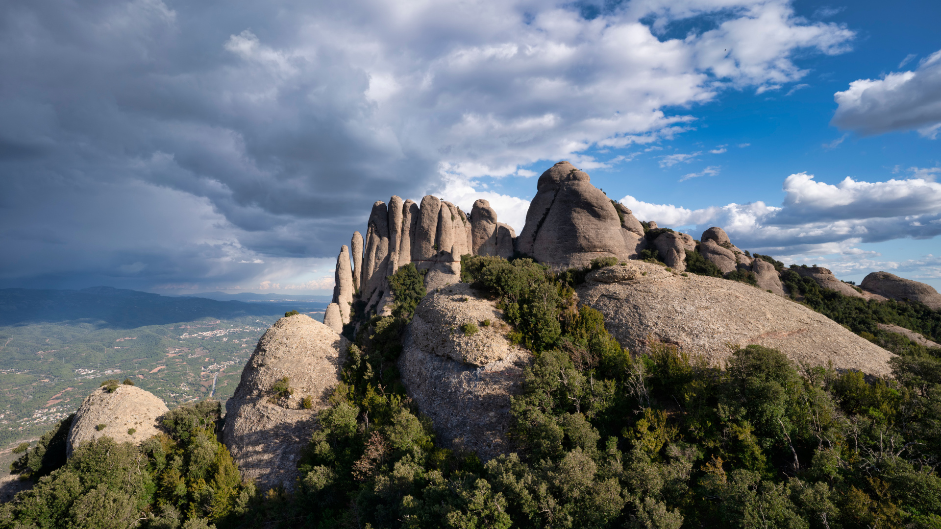 Boulders under the blue sky with storm clouds