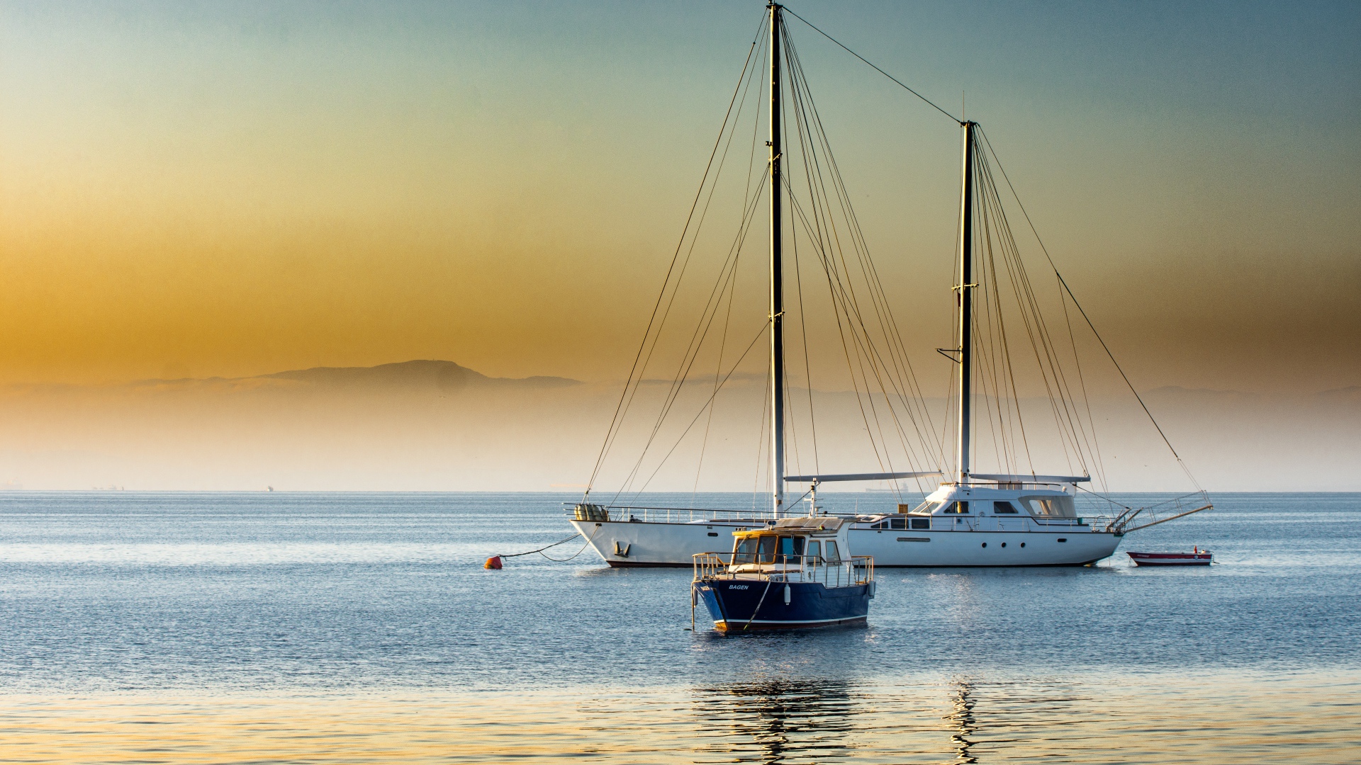 Two yachts at sea at sunset