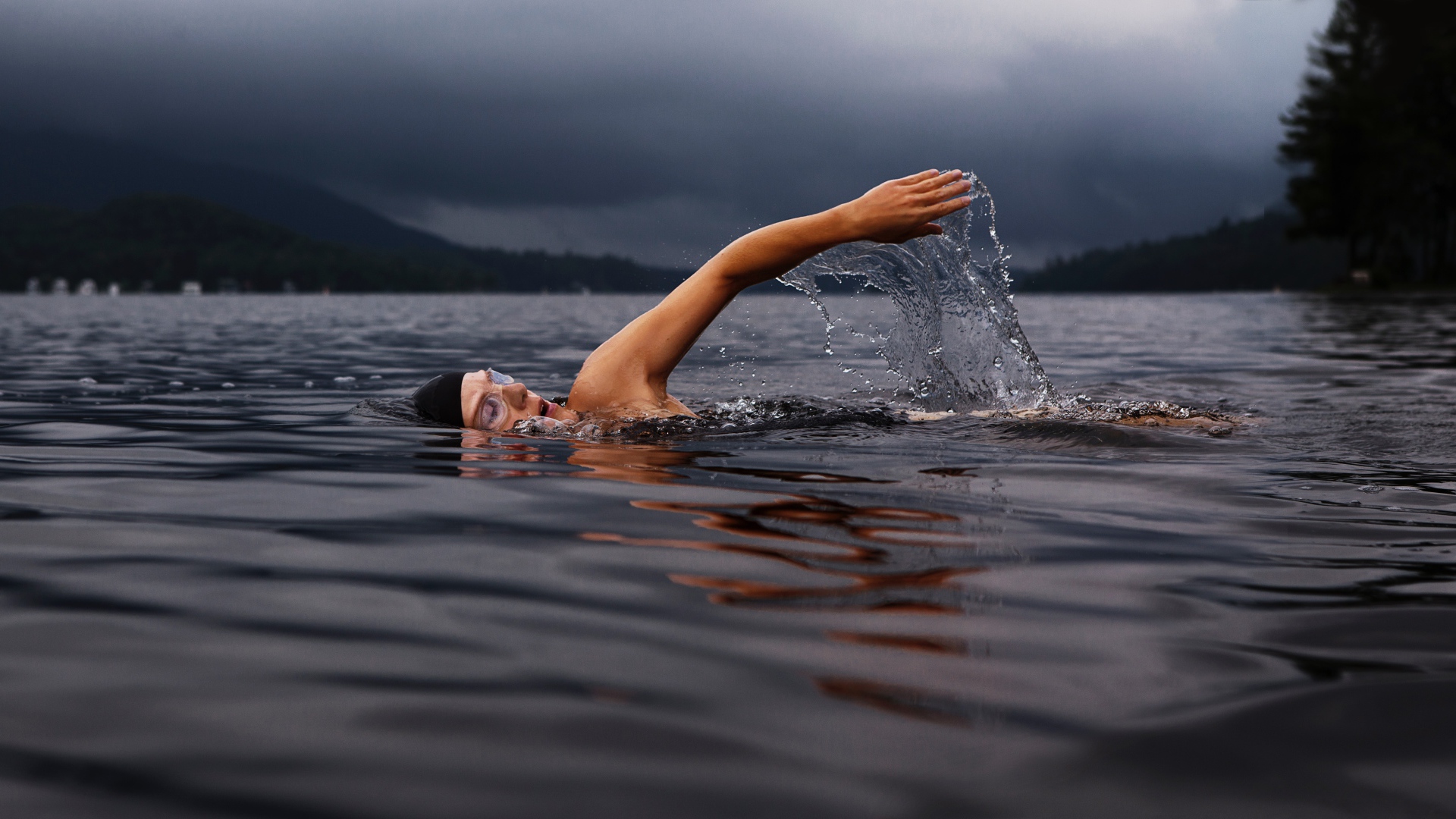 Male swimmer in the lake water