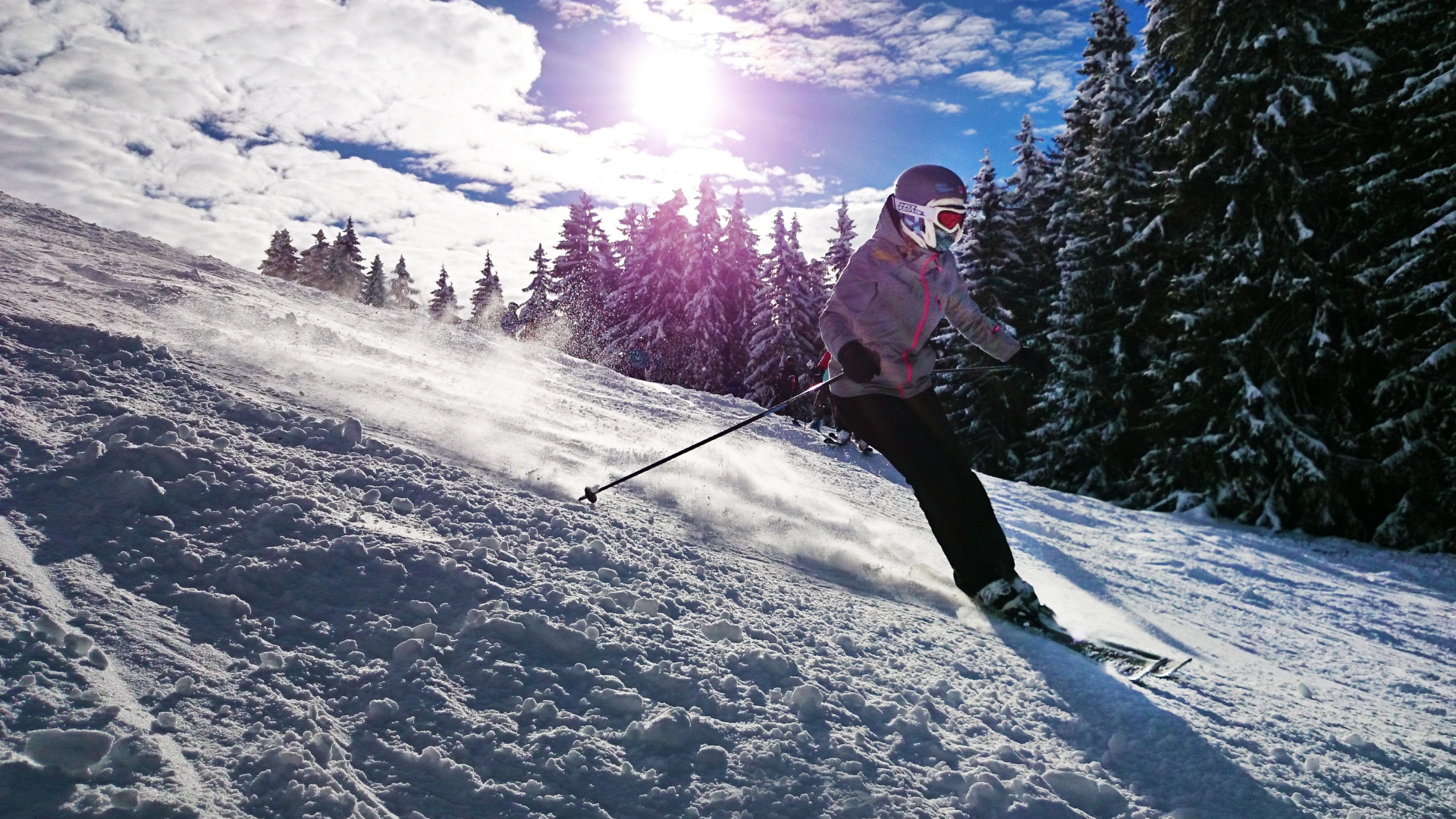 Девушка спускается на лыжах с горы