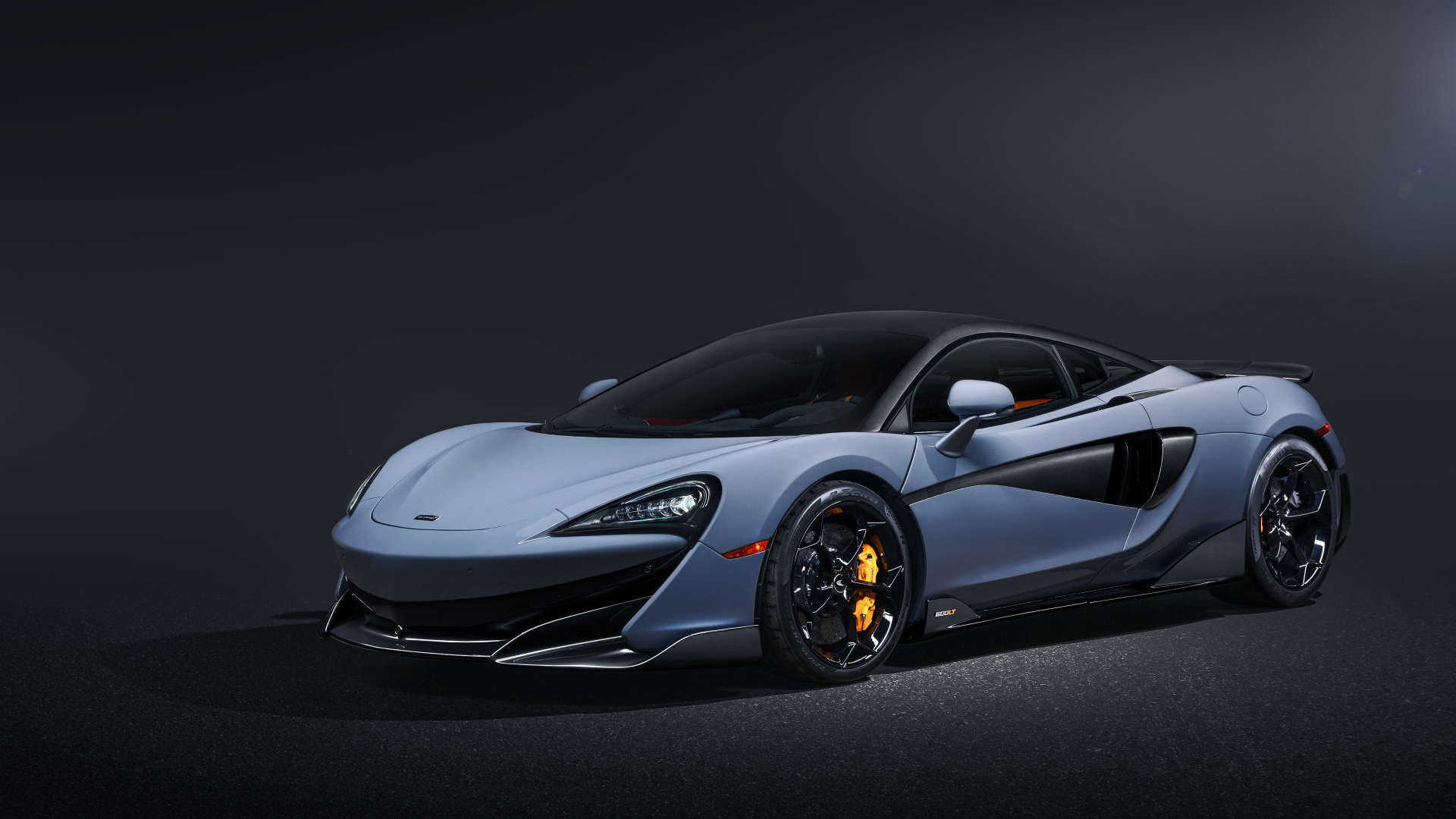 Быстрый автомобиль McLaren 600LT на черном фоне