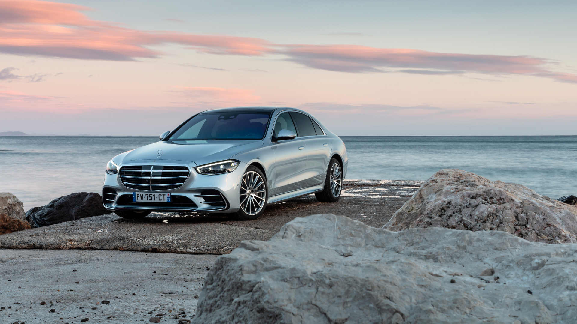 Silver car Mercedes-Benz S 350 D AMG Line against the background of the sea