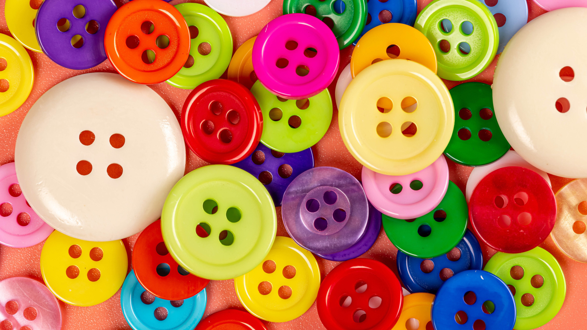 Many multi-colored buttons of different sizes