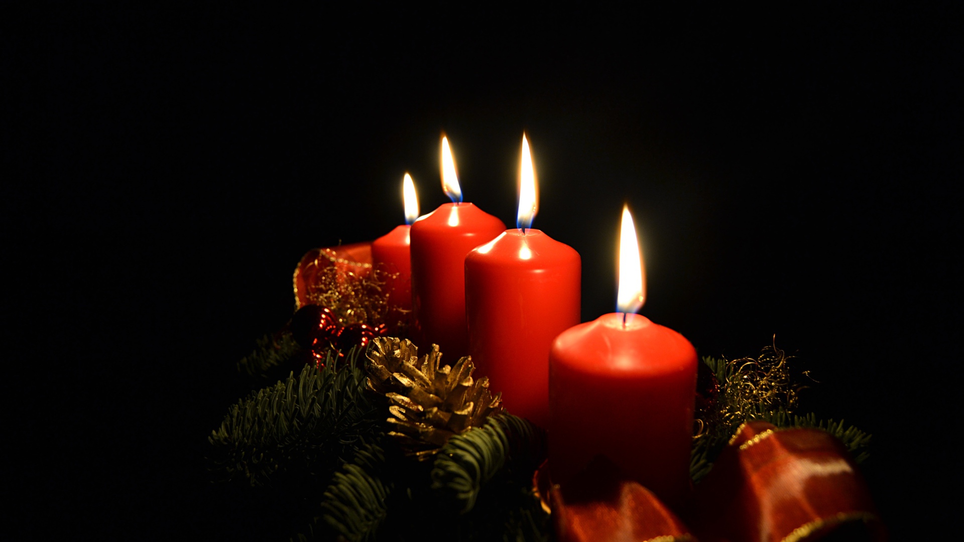 Red holiday candles on black background