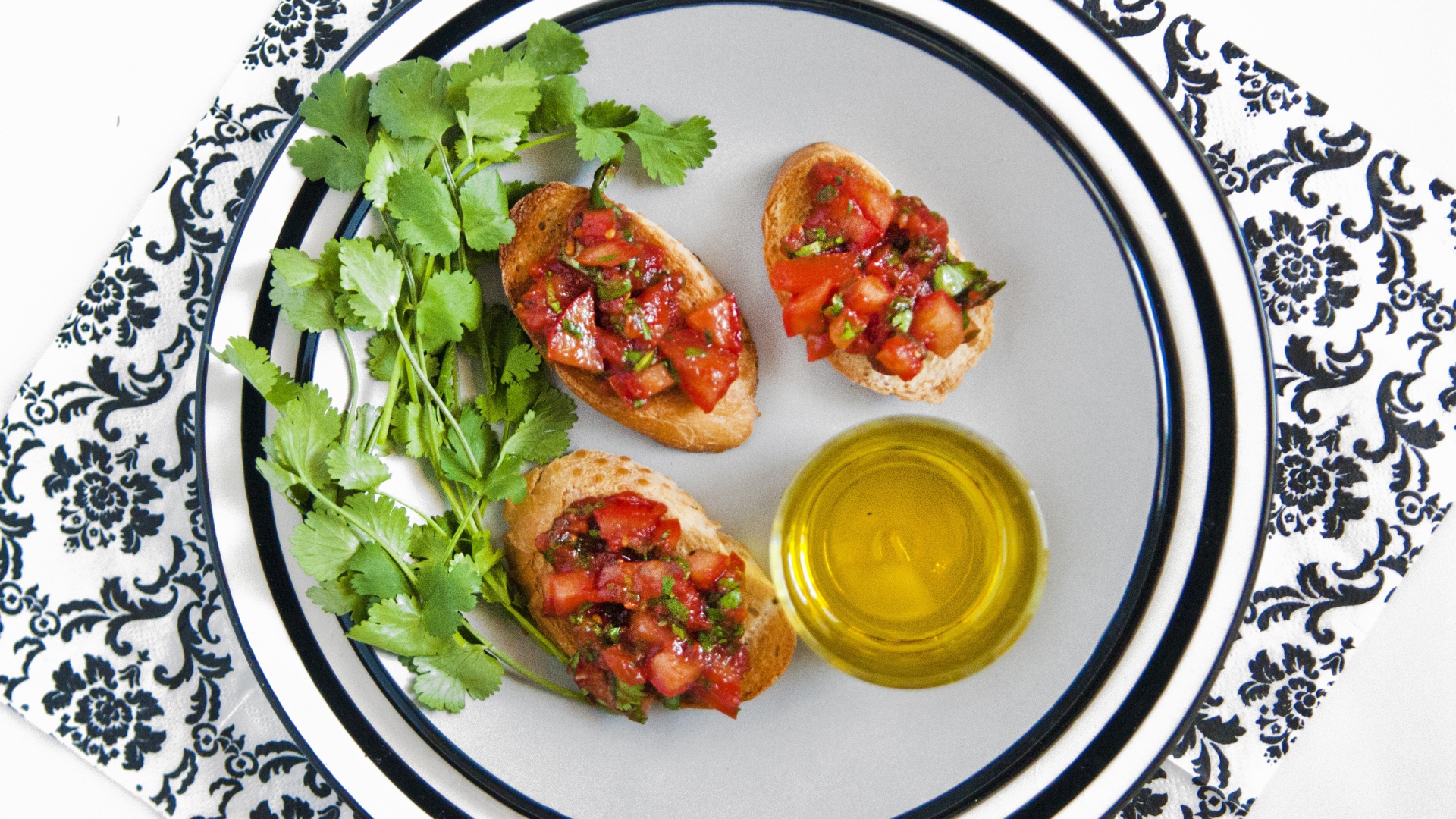 Бутерброды с помидорами на тарелке с петрушкой и маслом