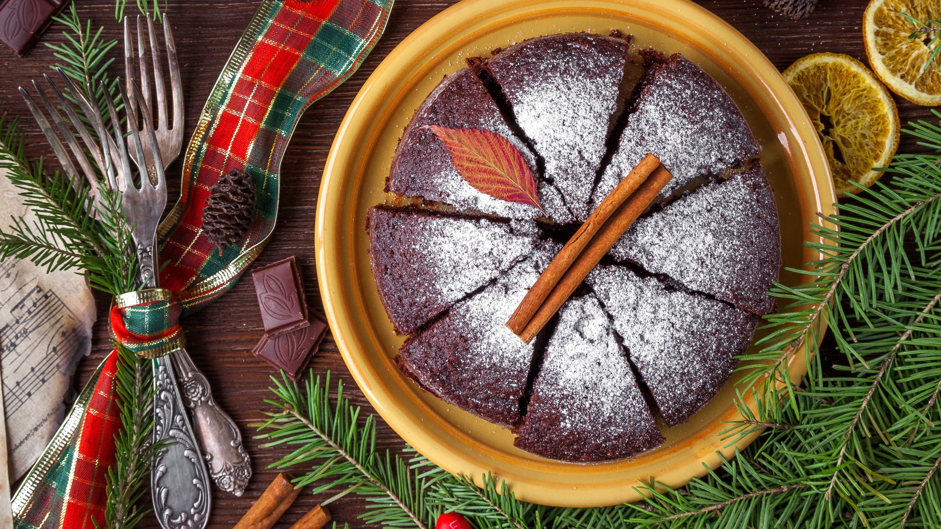 Пирог с сахарной пудрой на столе со столовыми приборами