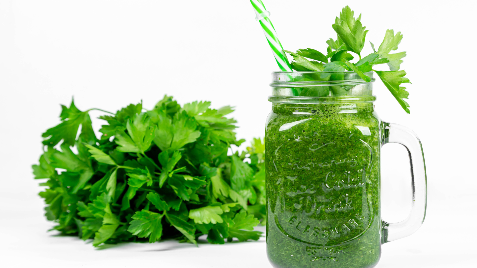 Green smoothie on the table with parsley