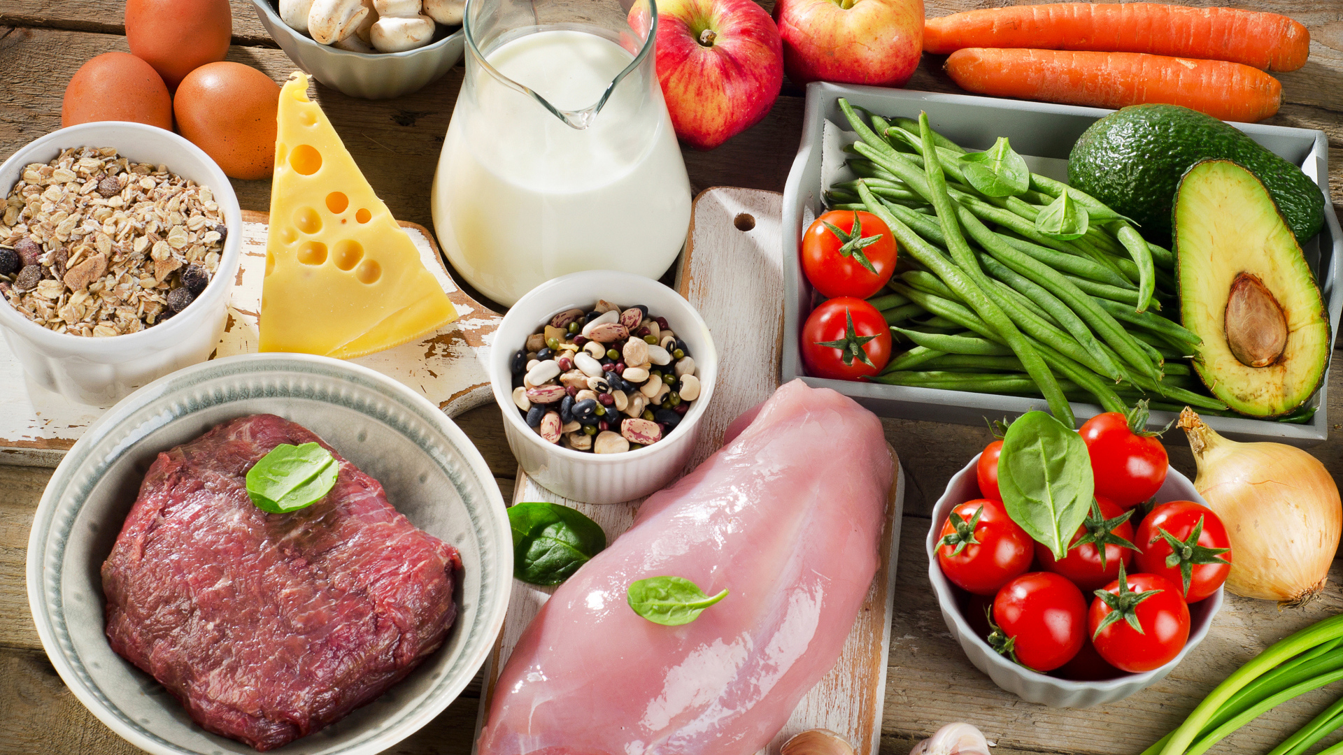 Fresh meat on the table with vegetables and apples