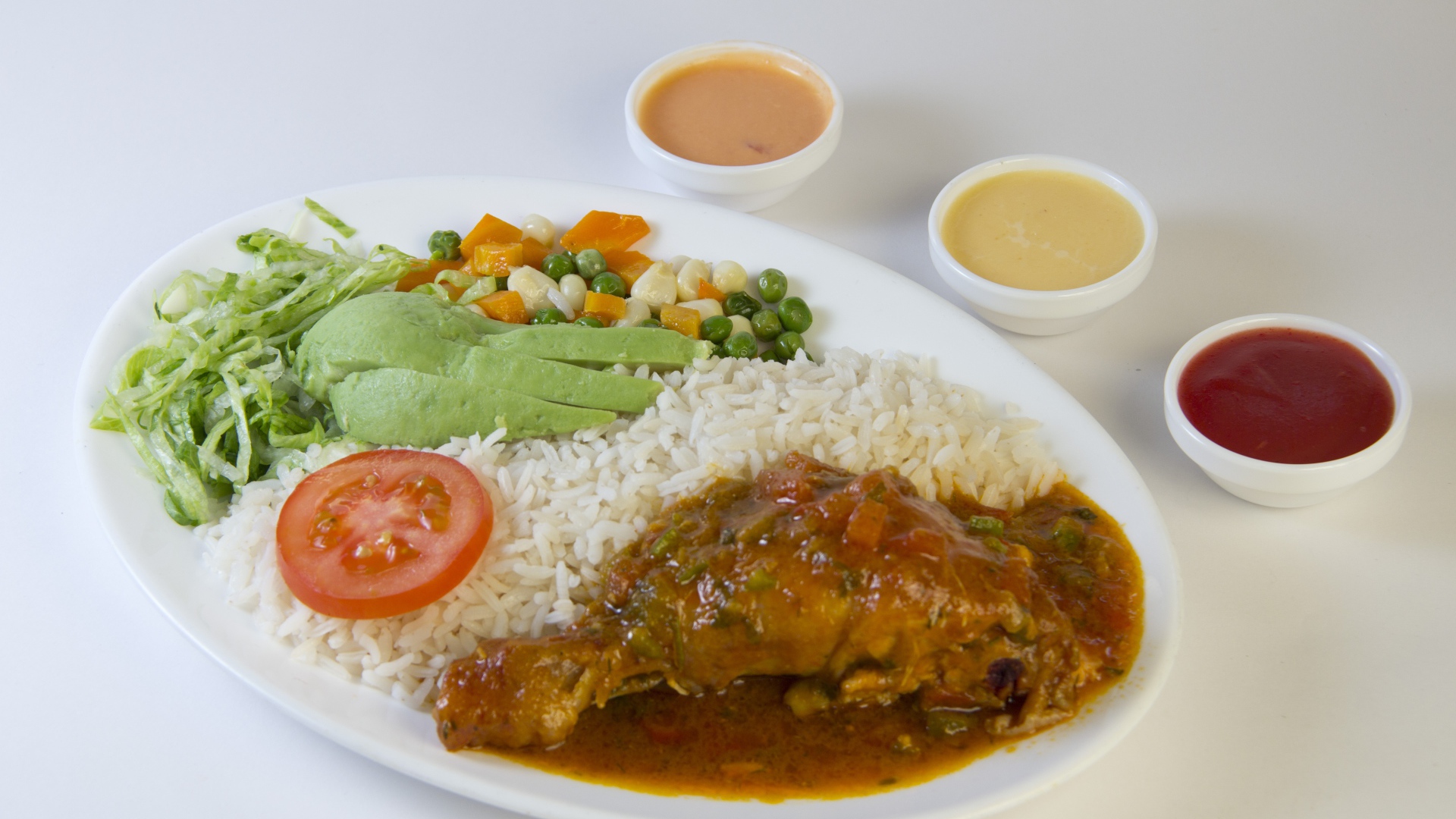 Rice with chicken and vegetables on the table with sauce