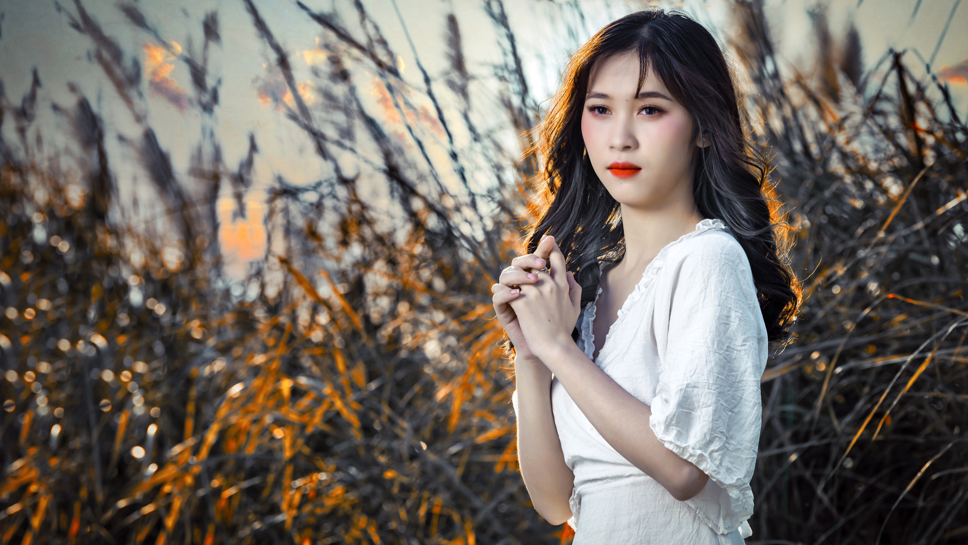 Молодая девушка азиатка в белом платье на закате