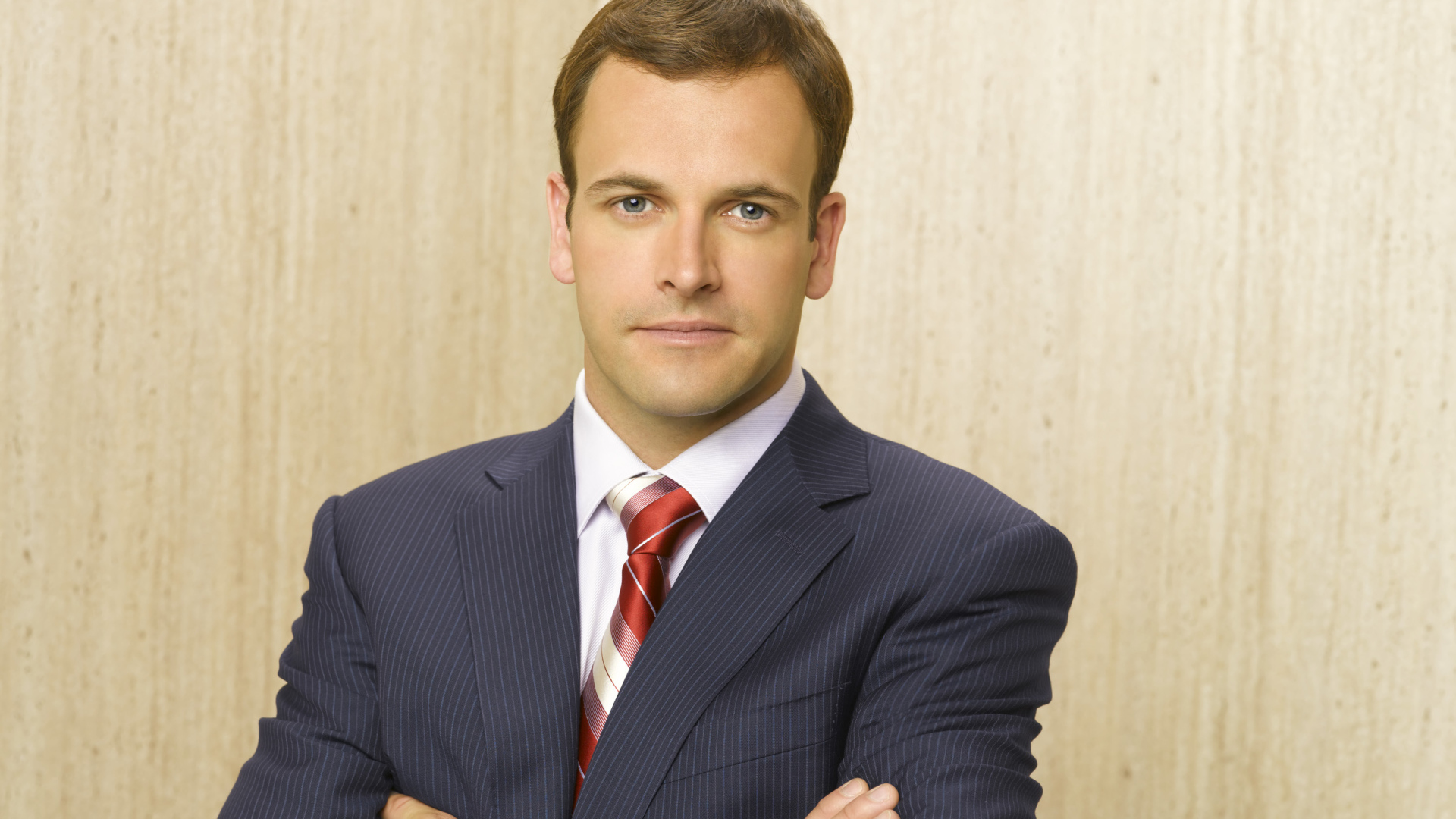 Актер Джонни Ли Миллер в костюме у стены